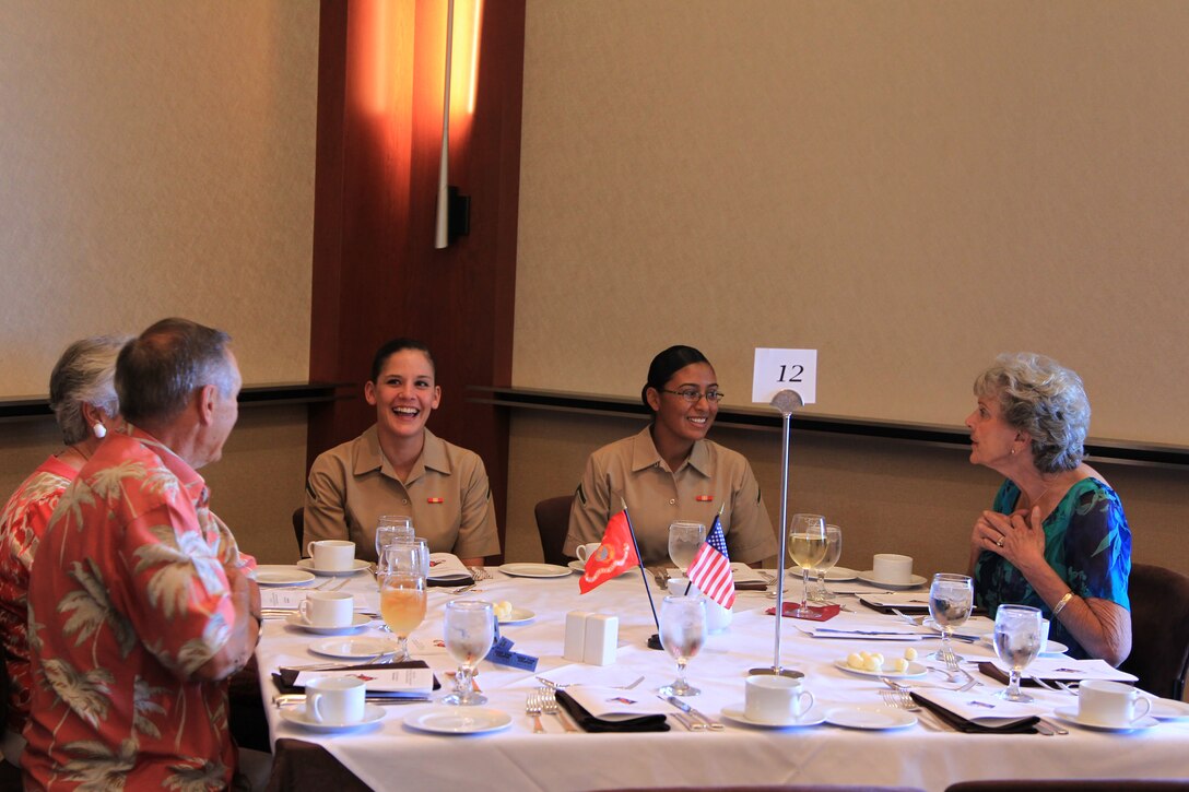 Marines laugh with members of the Lower Desert community during a luncheon held in honor of Women Marines' at the Indian Wells Golf Resort in Indian Wells, Calif., April 21, 2012. The luncheon was hosted by the Mitchell Paige Medal of Honor Chapter of the 1st Marine Division Association and is paid for through donations by the association's members and a silent auction held during the lunch. (Official USMC photo by Sgt. Heather Golden)