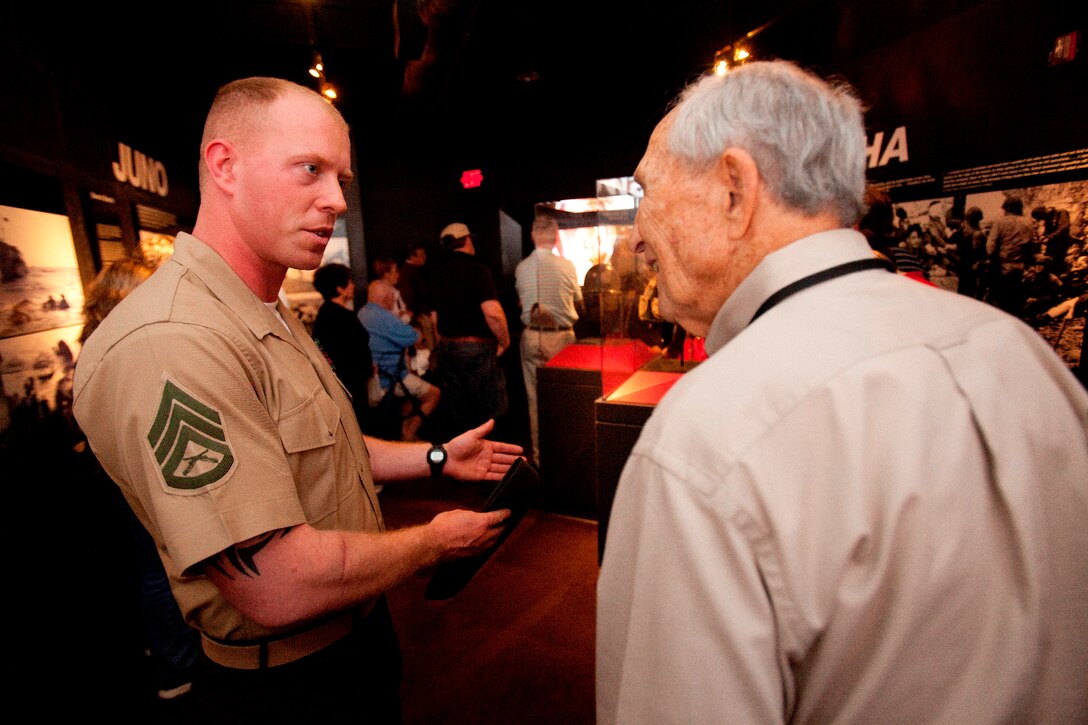 Bert Stolier, a Marine Raider who volunteers at the National World War II Museum in New Orleans, talks to Staff Sgt. Robert I. Manion, 26th Marine Expeditionary Unit Chemical, Biological, Radiological and Nuclear defense chief, about his experiences in World War II, April 21, 2012. The 26th MEU is providing support to the commemoration of the Battle of New Orleans. Starting April and continuing through 2015, the Navy, Marine Corps, and Coast Guard will commemorate the Bicentennial of the War of 1812 and the Star Spangled Banner. The War of 1812 celebration will commemorate the rich Naval history and showcase the capabilities of today's Navy-Marine Corps team. (Official Marine Corps photo by Lance Cpl. Scott L. Tomaszycki)
