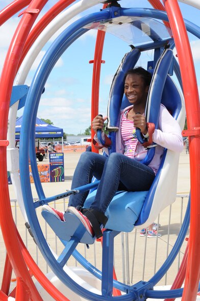 BARKSDALE AIR FORCE BASE, La. -- A visitor attending the Barksdale Air Force Base 2012 Defenders of Liberty Air Show takes a turn on a ride April 21. The air show featured a variety of aerial acts including the Air Force Thunderbirds. (U.S. Air Force photo/Senior Airman Sean Martin) (Released)