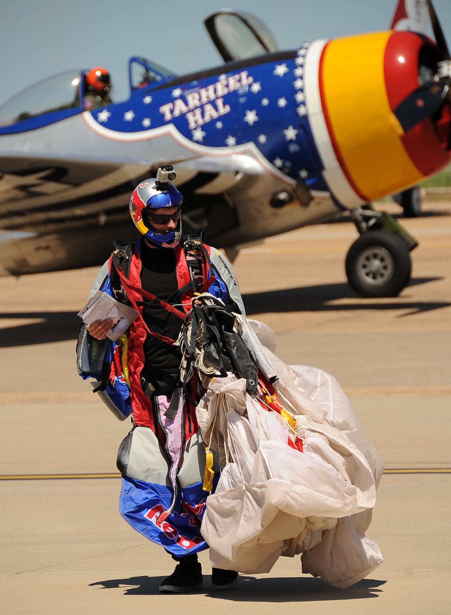 A Red Bull Jumper gathers his parachute after landing on the infield during the Defenders of Liberty 2012 Air Show on Barksdale Air Force Base, La., April 21. More than 20 aerial acts were presented to the crowd throughout the air show, headlined by the U.S. Air Force Thunderbirds. (U.S. Air Force photo/Staff Sgt. Amber Ashcraft) (RELEASED)