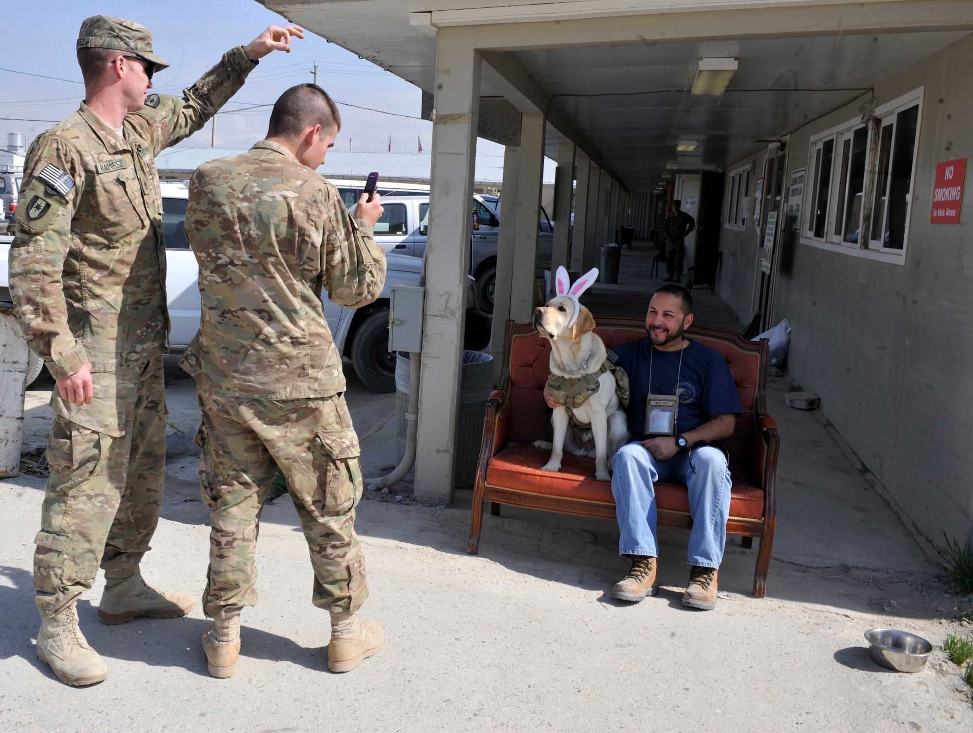 Major Timmy poses for pictures at an Easter promotion event at Bagram Airfield, Afghanistan, April 13, 2012. Timmy is a combat stress therapy dog with the 528th Combat and Operational Stress Control Team. Timmy has been at Bagram for 22 months as a part of his two-year tour in the COSC’s mission. By allowing the familiar comfort of petting a dog, Timmy helps relieve stress to service members in the region. (U.S. Air Force photo/Airman 1st Class Ericka Engblom)