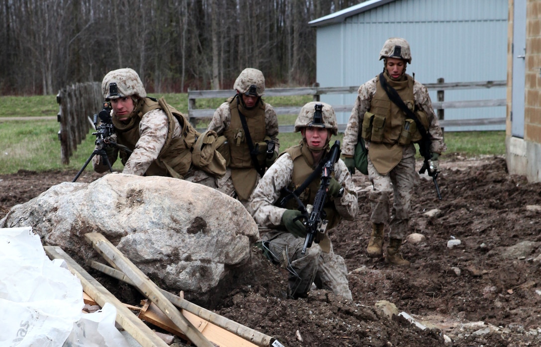 A squad of Marines from Company I, 3rd Battalion, 25th Marine Regiment, based out of Buffalo, N.Y. anxiously wait to maneuver toward a series of door-breaching obstacles as part of a small scale, bilateral exercise with the Canadian military April 20-22. The purpose of the training was to exchange infantry strategies and tactics as well as further enhance relationships and interoperability between the two military components.  (U.S. Marine Corps Photo by Cpl. Lucas Vega)