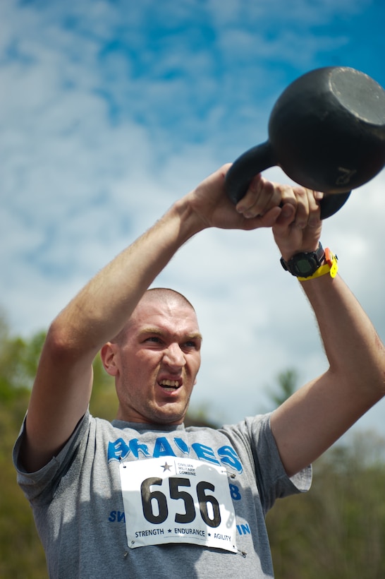 Lance Cpl. Jonathan Zill, Company B ceremonial marcher, lifts a kettlebell during a timed event at the beginning of the Civilian Military Combine at Bryce Resort, Va., April 21, 2012. The Combine, a weight lifting competition followed by a mountainous 6-mile obstacle course, was the fourth event in the 2012 Commander's Cup series.