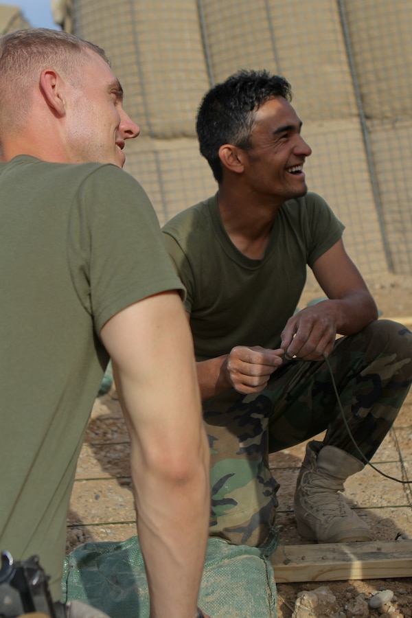 FORWARD OPERATING BASE GERONIMO – Captain Stephen Walker, the operations advisor with the Embedded Training Team, 2nd Battalion, 6th Marine Regiment, builds a terrain model with Afghan National Army 1st Sgt. Mubarak, the operations first sergeant with 1st Kandak, 1st Brigade, 215th Corps, March 21, 2012. Mubarak works with the ETT daily and said he enjoys working with Walker because he takes his job seriously. Walker said he enjoys working with Mubarak because Mubarak is very personable and wants to get the job done.