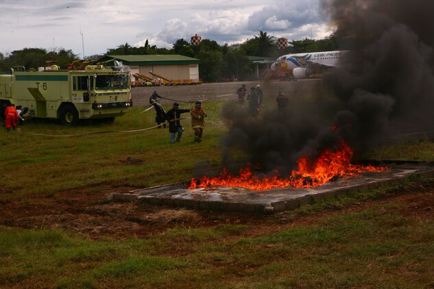 A Puerto Princesa Airport  Aircraft Rescue and Firefighting team, along with a U.S. Marine ARFF team, put out a training fire on the PPA flight line in Puerto Princesa, Palawan, Republic of the Philippines April 22, 2012. The fire fighters trained together with U.S. Marines in support of Balikatan 2012  Task Force Palawan. BK12, in its 28th iteration, is a bilateral, joint exercise conducted annually between the Republic of the Philippines and U.S. military members. The U.S. Marines are with Aviation Operations Company, Marine Wing Support Squadron 172, Marine Wing Support Group 17, 1st Marine Aircraft Wing, III Marine Expeditionary Force.