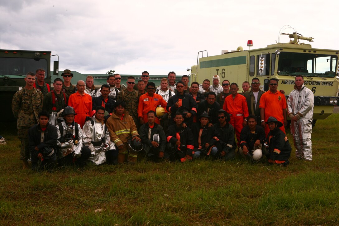 The Puerto Princesa Airport Aircraft Rescue and Fire Fighting team and U.S. Marine ARFF teams pose for a group photo April 22, 2012 at Puerto Princesa Airport in Puerto Princesa, Palawan, Republic of the Philippines. Both nations trained with one another during Balikatan 2012 Task Force Palawan. BK12, in its 28th iteration,  is a bilateral, joint exercise conducted annually between Republic of the Philippines and U.S. military members.  The U.S. Marines are with Aviation Operations Company, Marine Wing Support Squadron 172, Marine Wing Support Group 17, 1st Marine Aircraft Wing, III Marine Expeditionary Force.