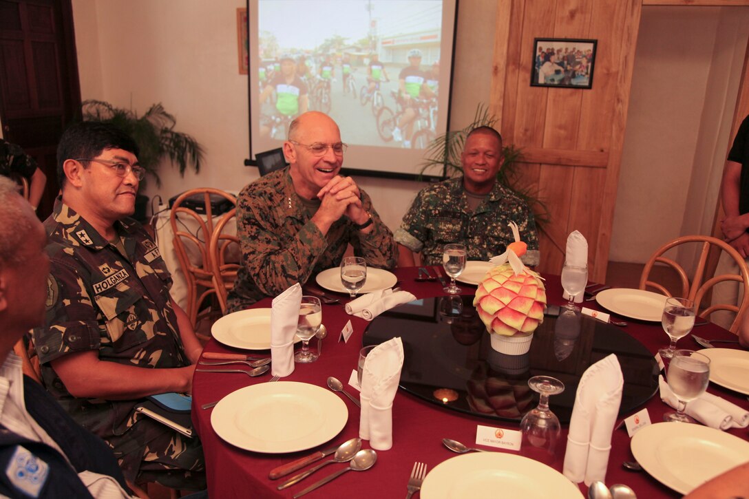 (From left) Gen. Carlos B. Holganza, commander of National Development Support Command for the Armed Forces of the Philippines, Lt. Gen. Duane  D. Thiessen, commanding general of Marine Forces Pacific, and AFP Marine Lt. Gen. Juancho Sabban, commander of Western Command, converse during lunch at Kinabuch Grill and Bar, Puerto Princesa City, Palawan, Republic of the Philippines on April 22. BK12 is an annual bilateral training exercise aimed at improving Republic of the Philippines and U.S. military force interoperability during planning, contingency and humanitarian assistance operations between the two nations while enhancing civil-military relations.