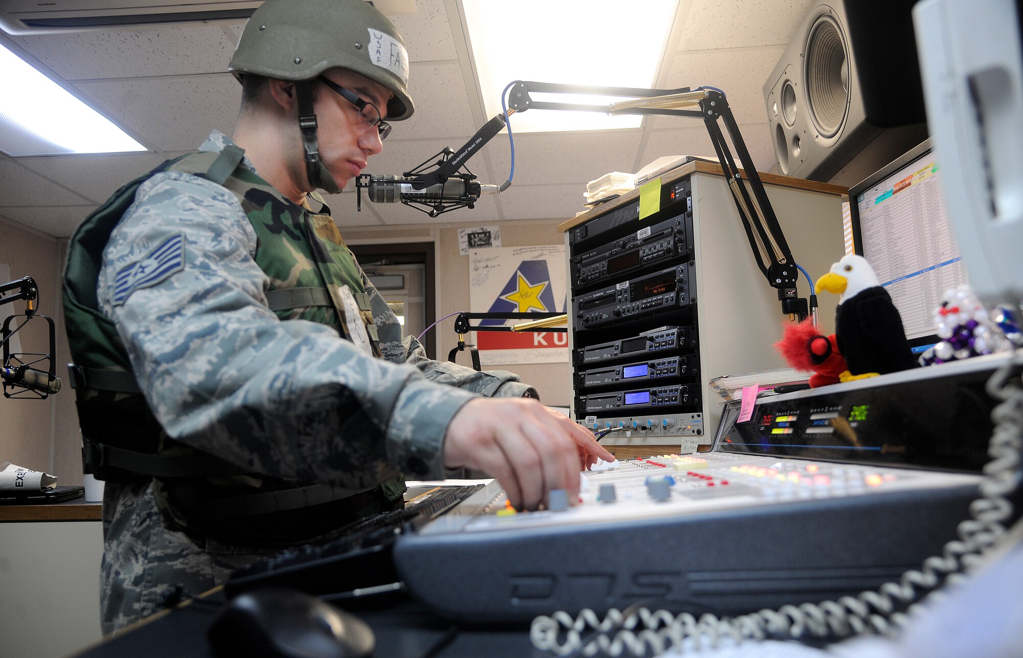 Tech. Sgt. Mike Falvo, American Forces Network Korea operations manager, prepares for a segment about combat readiness, safety and morale during the Beverly Midnight 12-02 at Kunsan Air Base, Republic of Korea, April 23, 2012. AFN broadcast 24 hours a day during 8th Fighter Wing exercises. (U.S. Air Force photo/Staff Sgt. Rasheen A. Douglas)