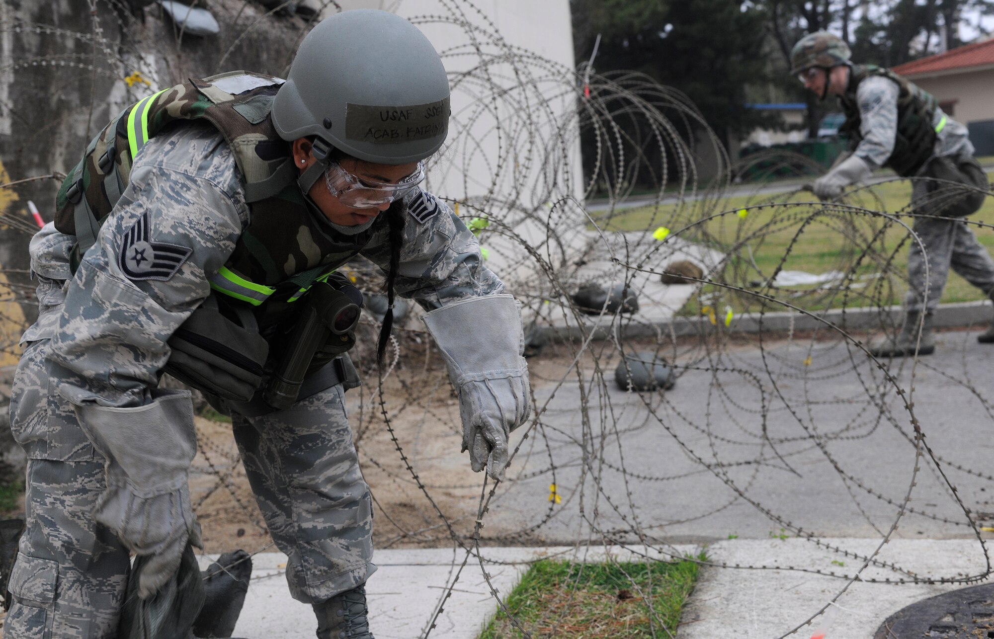 Staff Sergeant Katrina Acab and Senior Airman Jason Debelevich, 8th Communications Squadron members, unwind concertina-wire during exercise Beverly Midnight 12-02 at Kunsan Air Base, Republic of Korea, April 23, 2012. The Wolf Pack will find out results of the consolidated unit inspection May 2 once the inspection is complete and the IG has written their report. (U.S. Air Force photo/Staff Sgt. Rasheen A. Douglas) 