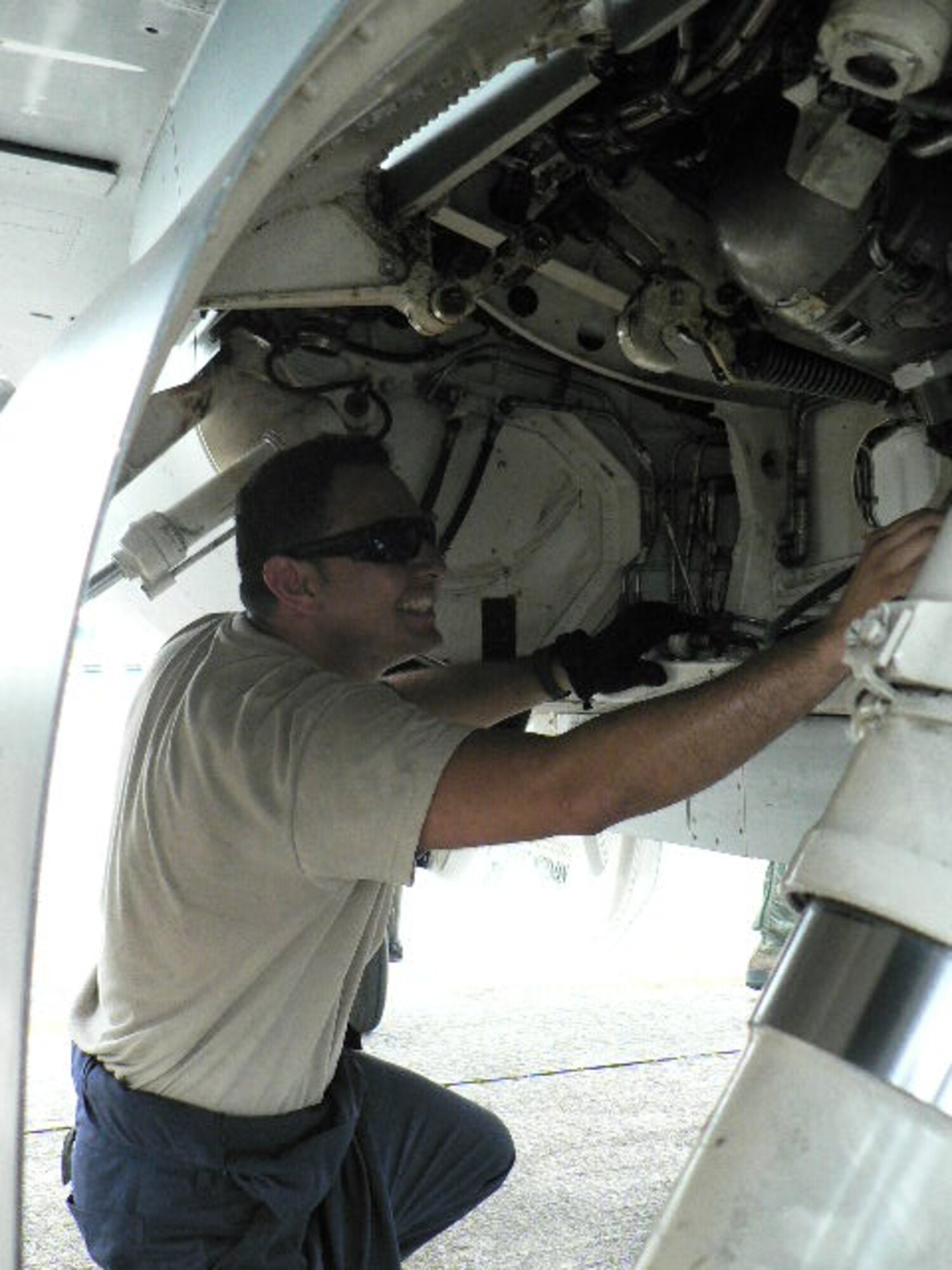 U.S. Air Force Airman 1st Class Sergio Campos, 13th Fighter Squadron crew chief, inspects an F-16 at Paya Lebar Air Base, Singapore, April 10, 2012. Pilots from the 13 and 14 FS trained on a variety of basic fighter and air combat maneuvers and air combat tactics with pilots from the Republic of Singapore Air Force as part of exercise Commando Sling 12-2. (Courtesy photo/Released)
