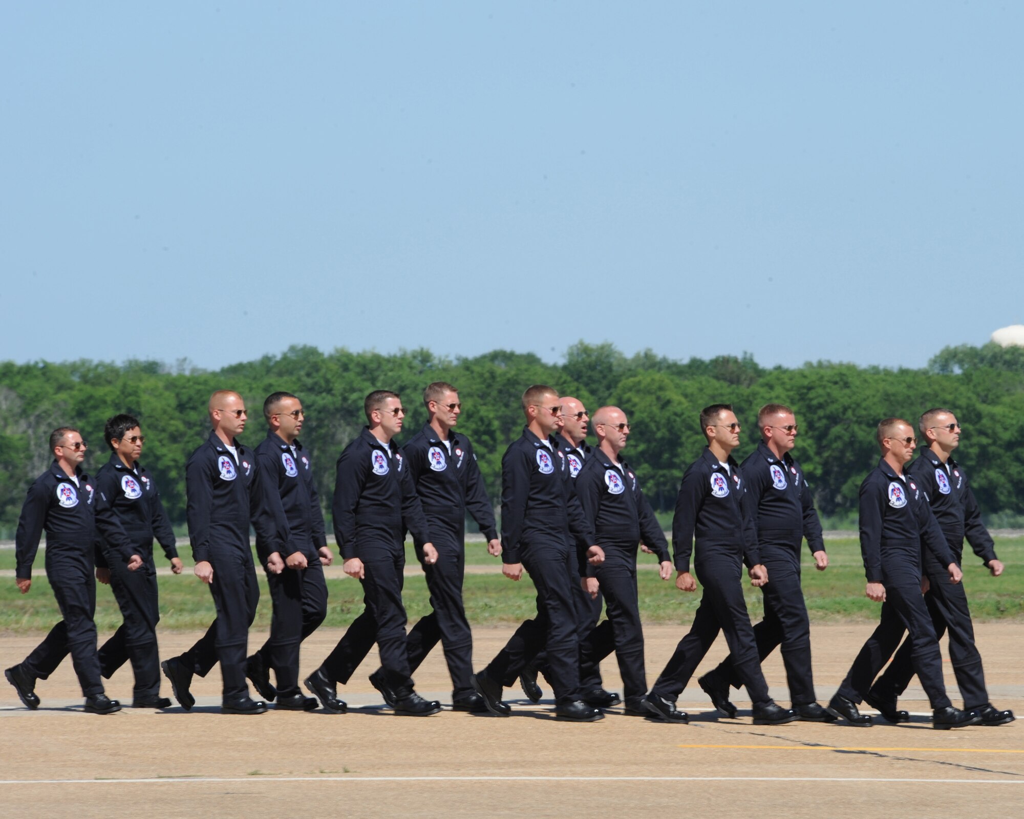 The U.S. Air Force Thunderbirds crew chiefs walk in formation after launching their aircraft during the Barksdale Air Force Base 2012 Defenders of Liberty Air Show April 21. The Air Force Air Demonstration Squadron Thunderbirds, based at Nellis Air Force Base, Nev., is the Air Force's premier aerial demonstration team, performing at air shows and special events worldwide. (U.S. Air Force photo/Senior Airman Sean Martin) (Released)