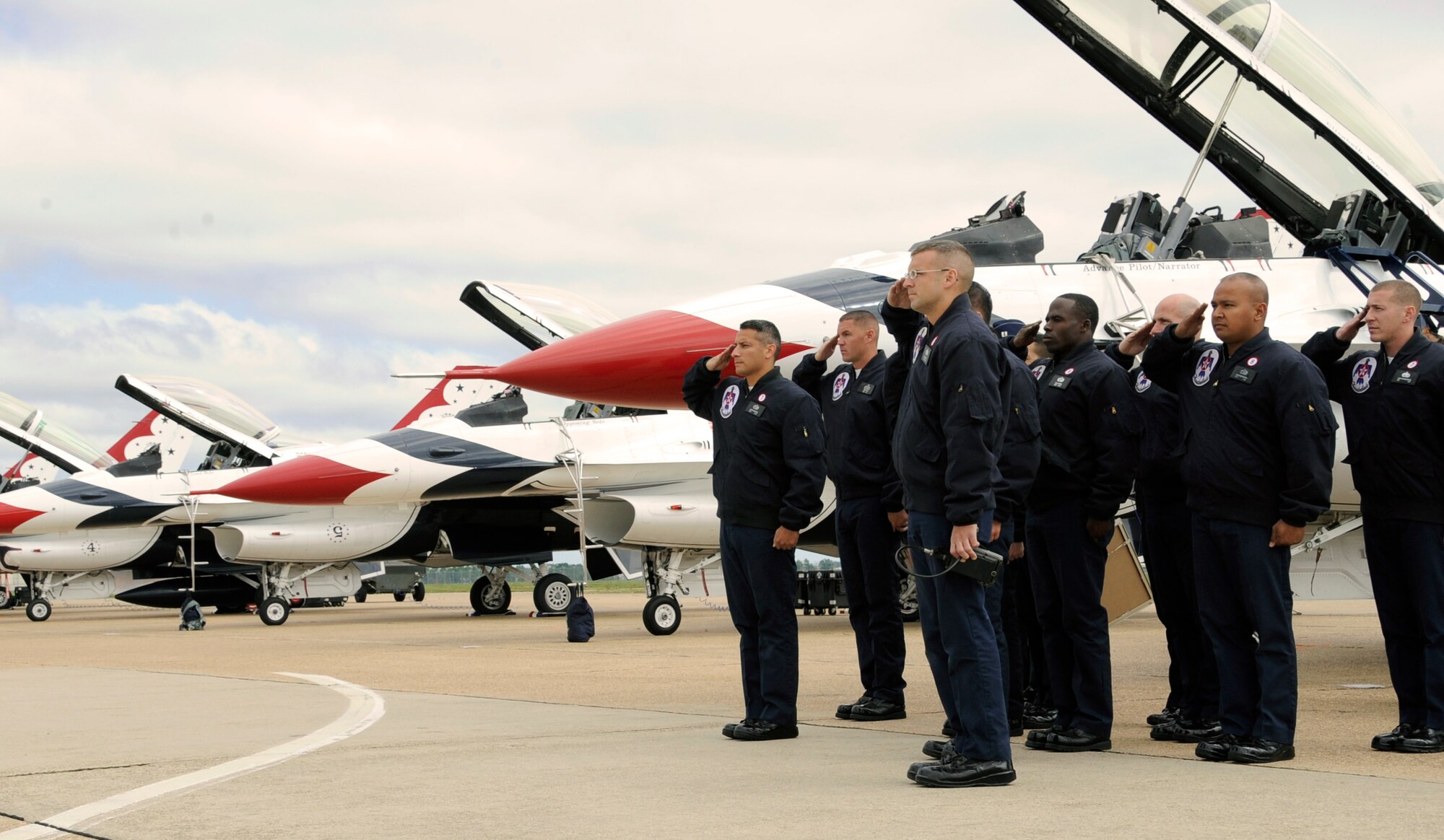 Members of the Air Force Air Demonstration Squadron Thunderbirds, stationed at Nellis Air Force Base, Nev., salute during the playing of the national anthem on Barksdale Air Force Base, La., April 21. The Thunderbirds headlined a full schedule of aerial acts performing at the base air show 21-22. (U.S. Air Force photo/Airman 1st Class Benjamin Gonsier)(RELEASED)