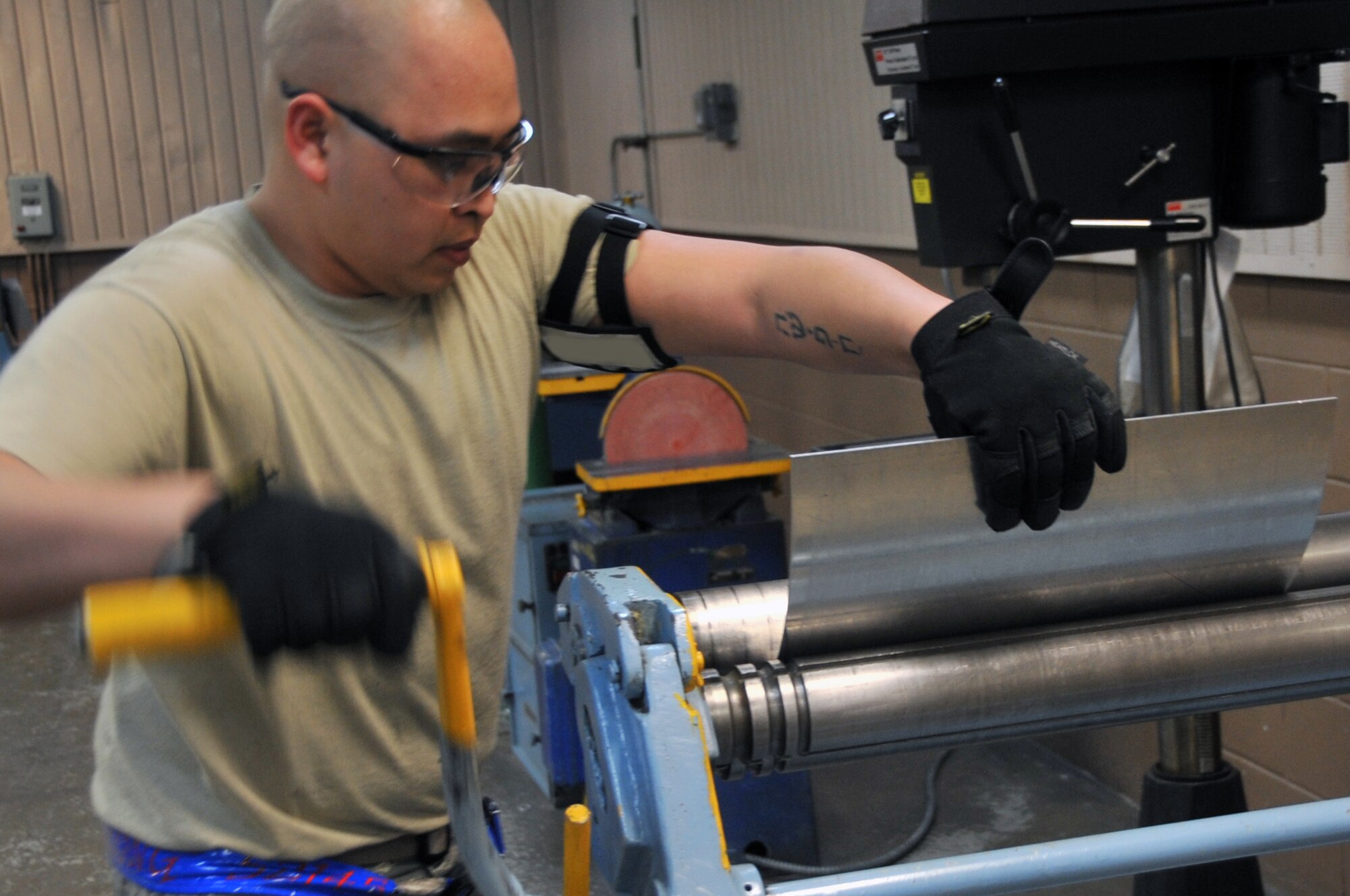 Senior Airman Thompson Kongmany, 51st Maintenance Squadron aircraft structural maintainer, uses a slip roller to bend sheet metal at the desired points at Osan Air Base, Republic of Korea, April 20, 2012. Kongmany was repairing bird-strike damage to a C-130 from Yokota Air Base, Japan. (U.S. Air Force photo/Staff Sgt. Craig Cisek)