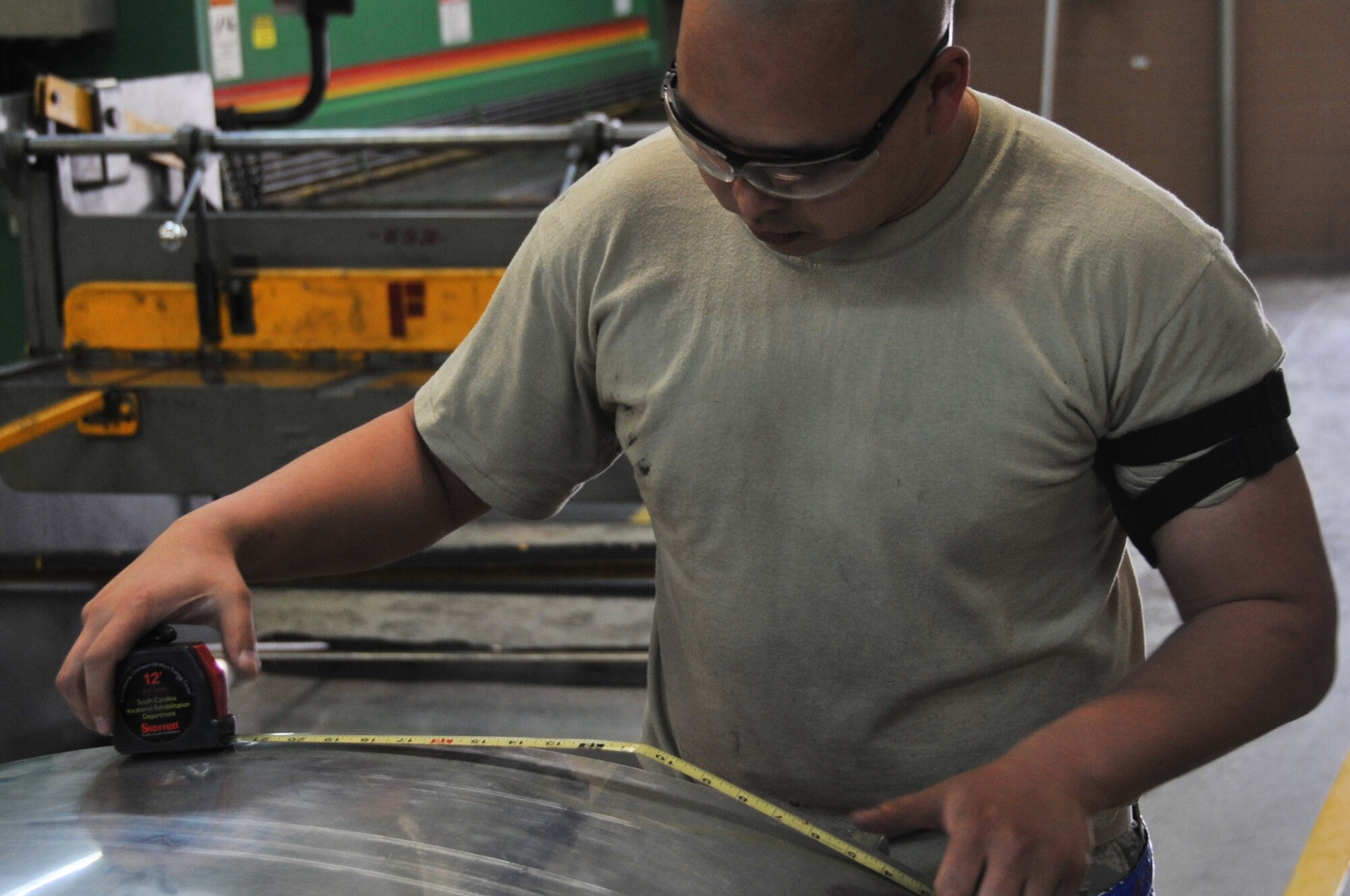 Senior Airman Thompson Kongmany, 51st Maintenance Squadron aircraft structural maintainer, measures out sheet metal prior to fabrication at Osan Air Base, Republic of Korea, April 20, 2012. Kongmany was repairing bird-strike damage to a C-130 Hercules from Yokota Air Base, Japan. (U.S. Air Force photo/Staff Sgt. Craig Cisek)