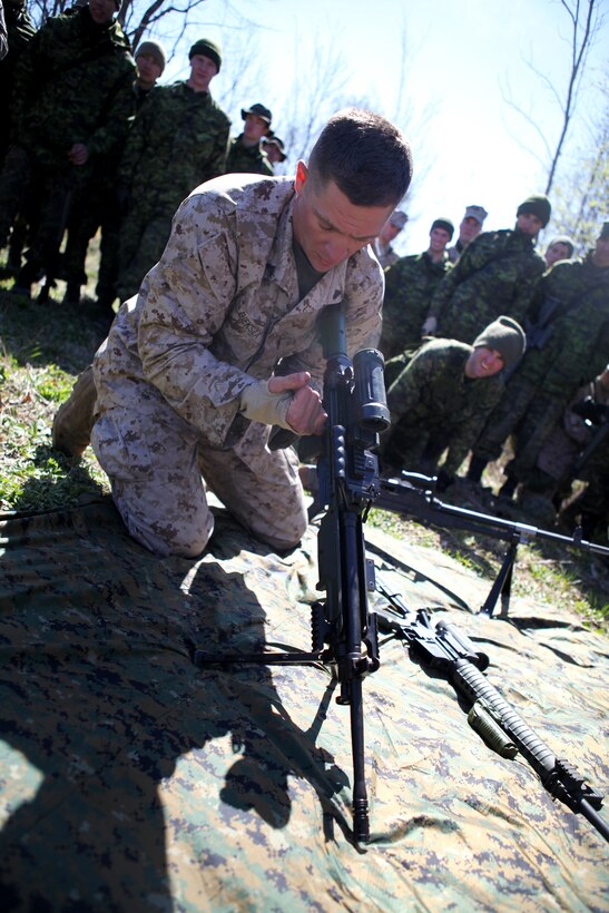 Cpl. Jesse Bieksza, a machine gunner with Company I, 3rd Battalion, 25th Marine Regiment, based out of Buffalo, N.Y., performs a function check on a Canadian Forces weapon system, similar to the U.S. Marine Corps’ M240B automatic machine gun during a friendly competition April 22 with the Royal Hamilton Light Infantry, Canadian Forces. The purpose of friendly competition, at the close of the exercise, was to develop camaraderie between the U.S and Canadian military components.  The small-scale, 48-hour, bilateral exercise was conducted to exchange infantry strategies and tactics as well as further enhance relationships and interoperability between the two military components.  (U.S. Marine Corps Photo by Cpl. Lucas Vega)