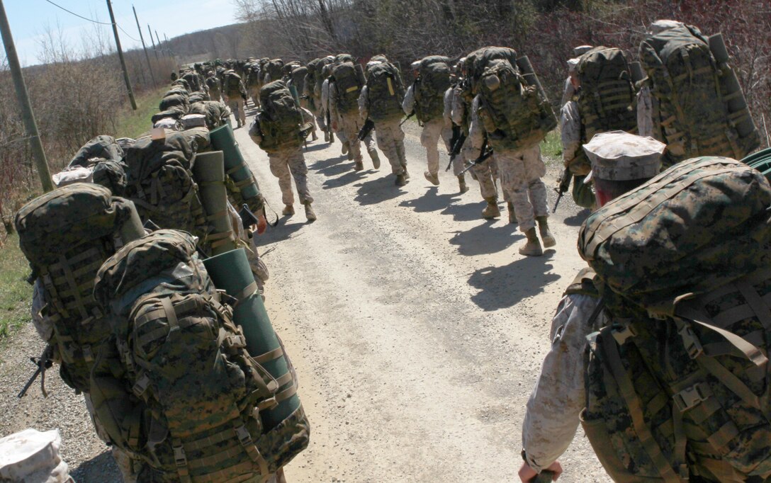 Marines from Company I, 3rd Battalion, 25th Marine Regiment, based out of Buffalo, N.Y., walk side by side, behind a company of Canadian Soldiers from the Royal Hamilton Light Infantry, Canadian Forces, based out of Hamilton, Ontario, April 22 during a field hike. The hike took place as part of a small-scale, 48-hour, bilateral training exercise between the U.S.  Marine Corps and Canadian Forces in efforts to exchange infantry strategies and tactics as well as further enhance relationships and interoperability between the two military components. (U.S. Marine Corps Photo by Cpl. Lucas Vega)