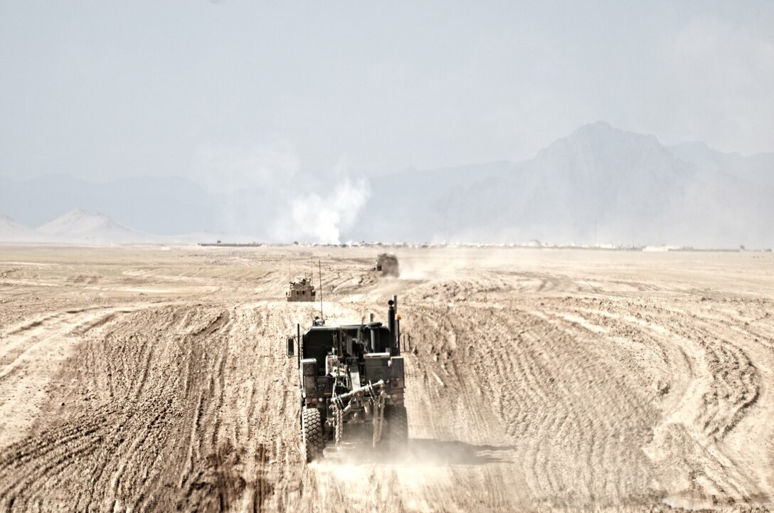 Alpha Company, Combat Logistics Battalion 4, 1st Marine Logistics Group (Forward), tactical vehicles cross an expanse of desert near Forward Operating Base Edinburgh, April 22. The combat logistics patrol supported counter-insurgency operations in the area by providing 235 tons of supplies and 5,000 gallons of fuel to multiple FOBs.