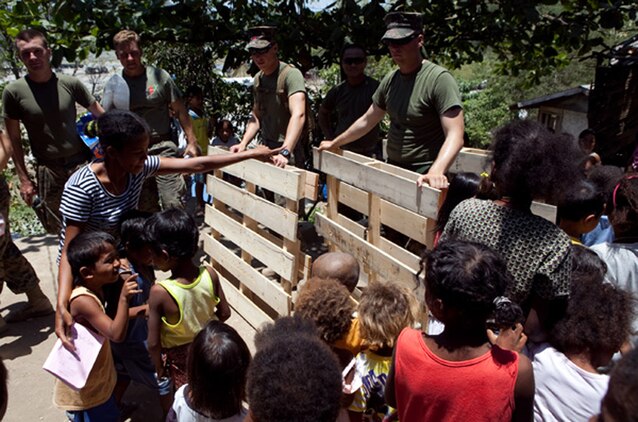 U.S. Marines participating in Exercise Balikatan 2012 repair a school in the Santa Juliana Village as children watch, April 23. Together villagers, Armed Forces of the Philippines and U.S. service members repaired two water pumps, hung tire swings in common areas, renovated the local schoolhouse and donated books and school supplies to children in need during Balikatan, which means "shoulder to shoulder" in Filipino. BK12 is an annual training event aimed at improving combined planning, combat readiness, humanitarian assistance and interoperability between the Armed Forces of the Philippines and United States.