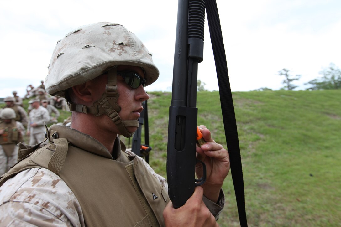 Lance Cpl. Adam R. Tornatore, helps an Afghan driver change a damaged tire on his truck at FOB Now Zad, Afghanistan, April 23. The Afghan truck was embedded in the CLB-4 convoy. Tornatore is a motor vehicle operator with CLB-4.