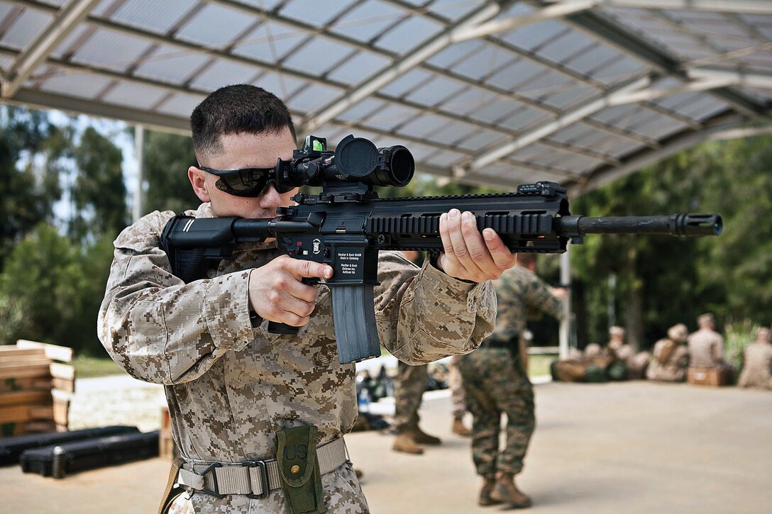 Lance Cpl. Zachary A. Whitman familiarizes himself with the M27 infantry automatic rifle in preparation for the Australian Army Skill at Arms Meeting 2012. AASAM is a multilateral, multinational event allowing Marines to exchange skills tactics, techniques and procedures with members of the Australian Army, as well as other international militaries in friendly competition. Whitman is a marksman with the III Marine Expeditionary Force detachment.