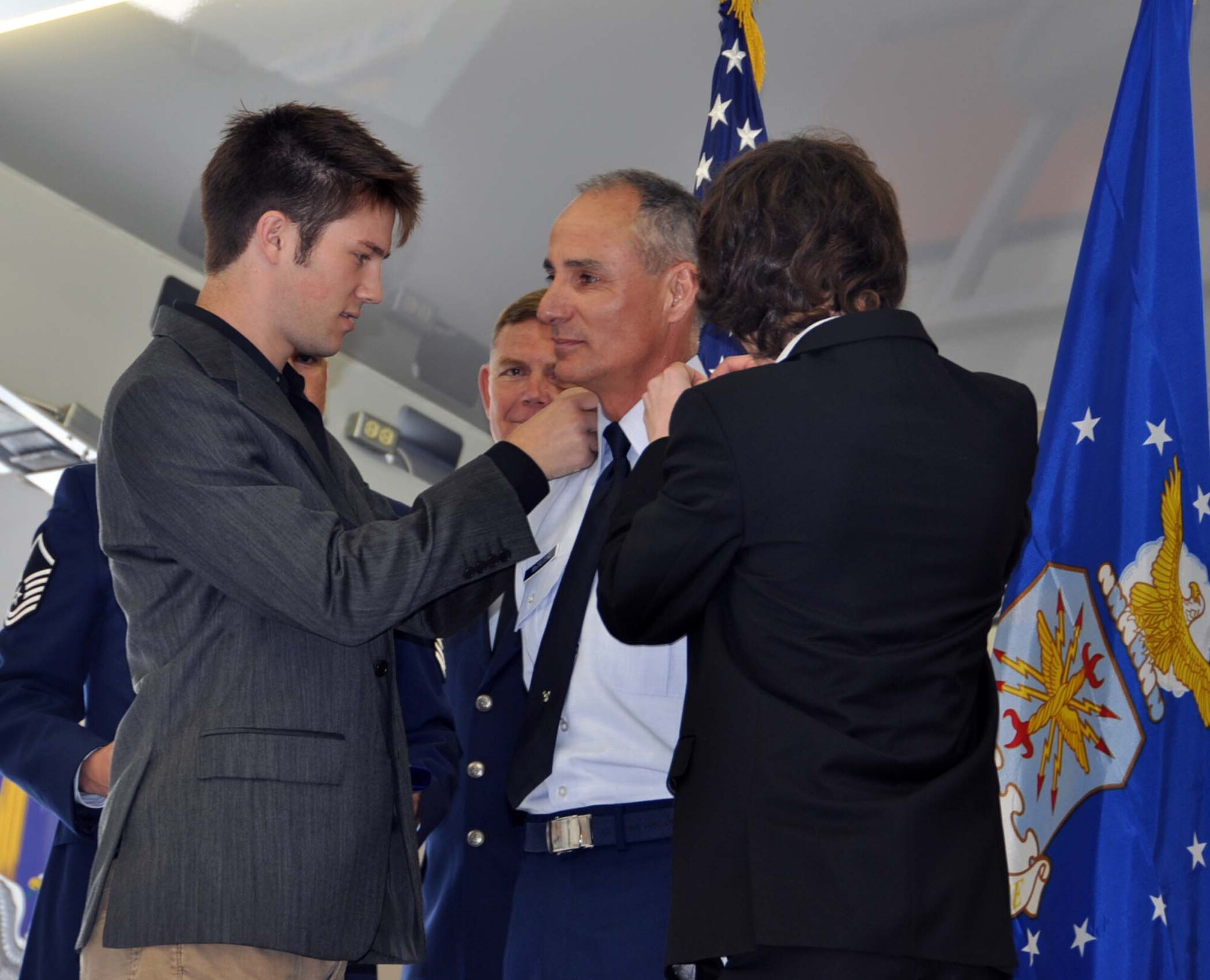 Brig. Gen. Karl McGregor, 452d Air Mobility Wing commander, stands at attention as his sons, Keegan (left) and Kolin slide stars on his epaulets during the general’s promotion ceremony at March Field, Sat., April 14, 2012. The event was scheduled for a Unit Training Assembly weekend, so March Air Reserve Base reservists could attend the celebration. (U.S. Air Force photo by Master Sgt. Linda Welz)