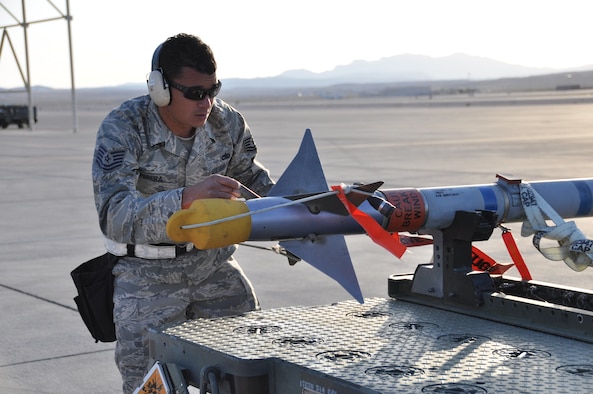 Tech. Sgt. Michael Perera, 926th Aircraft Maintenance Squadron weapons loader, inspects an AIM-9M Sidewinder missile during the quarterly weapons load competition at Nellis Air Force Base, Nev., on April 6. (U.S. Air Force photo/Maj. Jessica Martin)