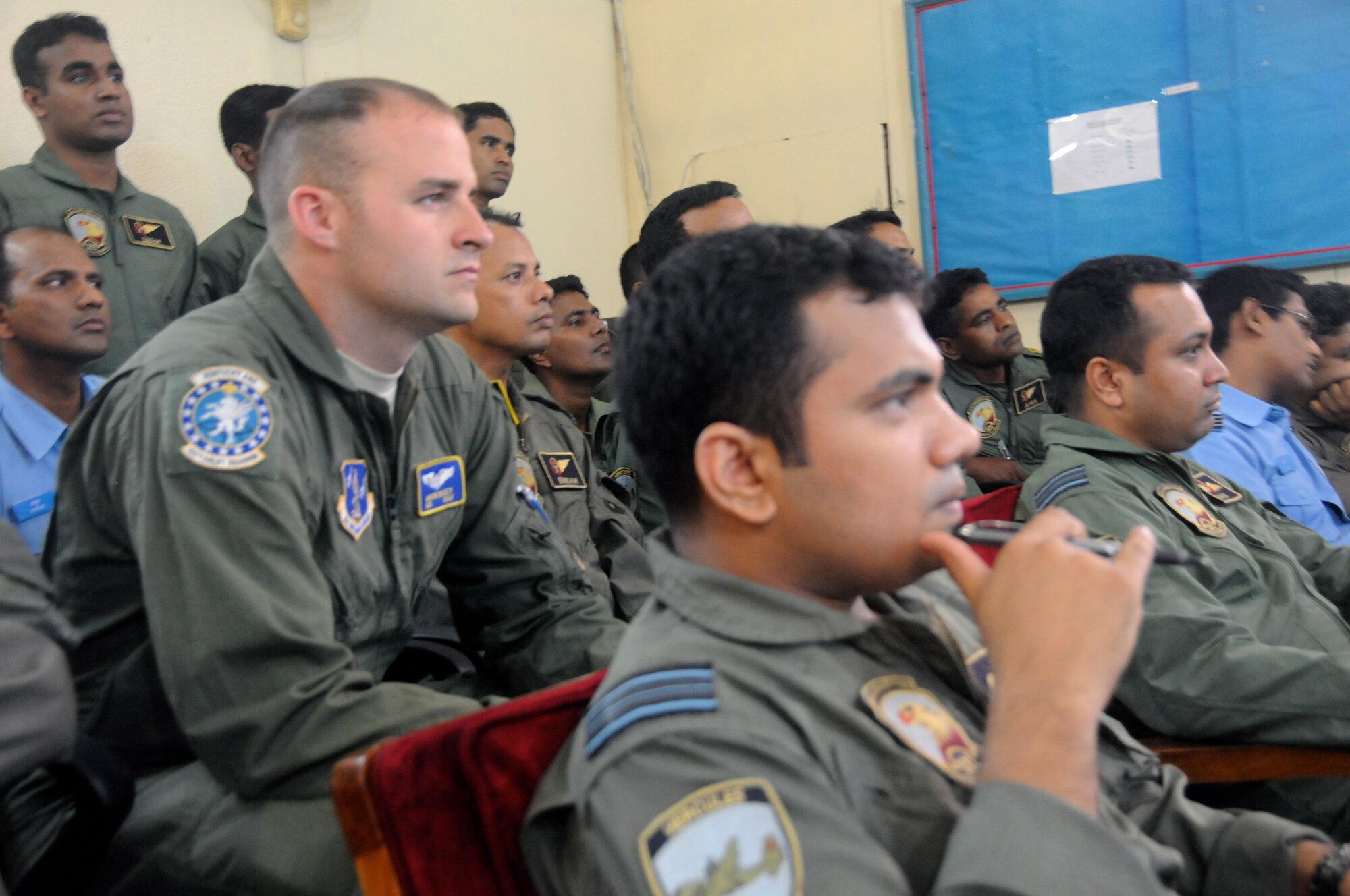 KURMITOLA AIR BASE, Bangladesh --Tech. Sgt. Joshua Shelby, loadmaster, Kentucky Air National Guard, sits in on a briefing with more than 20 Bangladesh air force airmen at Kurmitola Air Base, Bangladesh, April 22, 2012. Cope South is a six-day exercise where participants are scheduled to conduct cooperative flight operations, to include aircraft generation and recovery, low-level navigation, tactical airdrop and air-land missions as well as conduct subject-matter expert exchanges in the operations, maintenance and rigging disciplines. (U.S. Air Force photo by 1st Lt. Cammie Quinn)