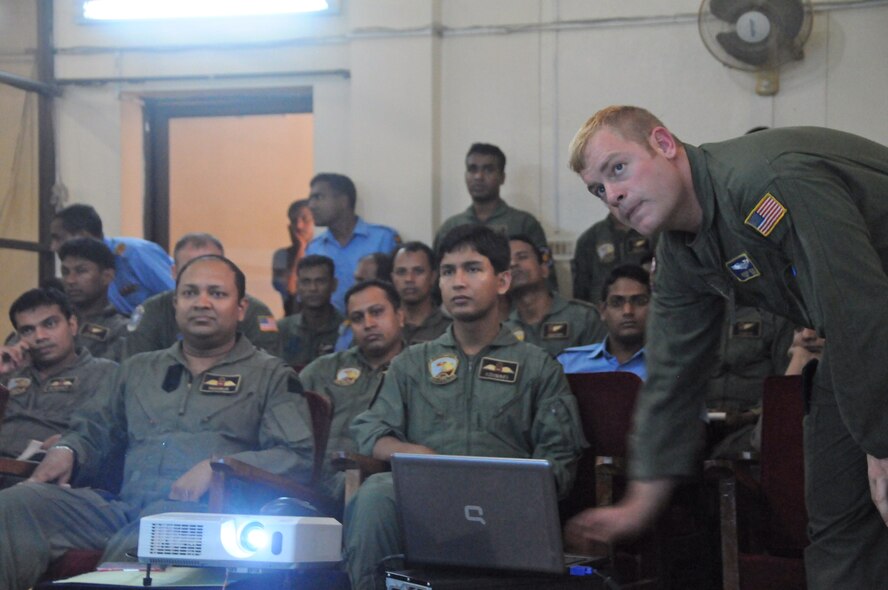 Tech. Sgt. Joshua Selby, loadmaster, Kentucky Air National Guard, shared his knowledge of heavy equipment airdrop procedures with an audience of more than 20 Bangladesh air force airmen at Kurmitola Air Base, Bangladesh, April 22, 2012. (U.S. Air Force photo by 1st Lt. Cammie Quinn)