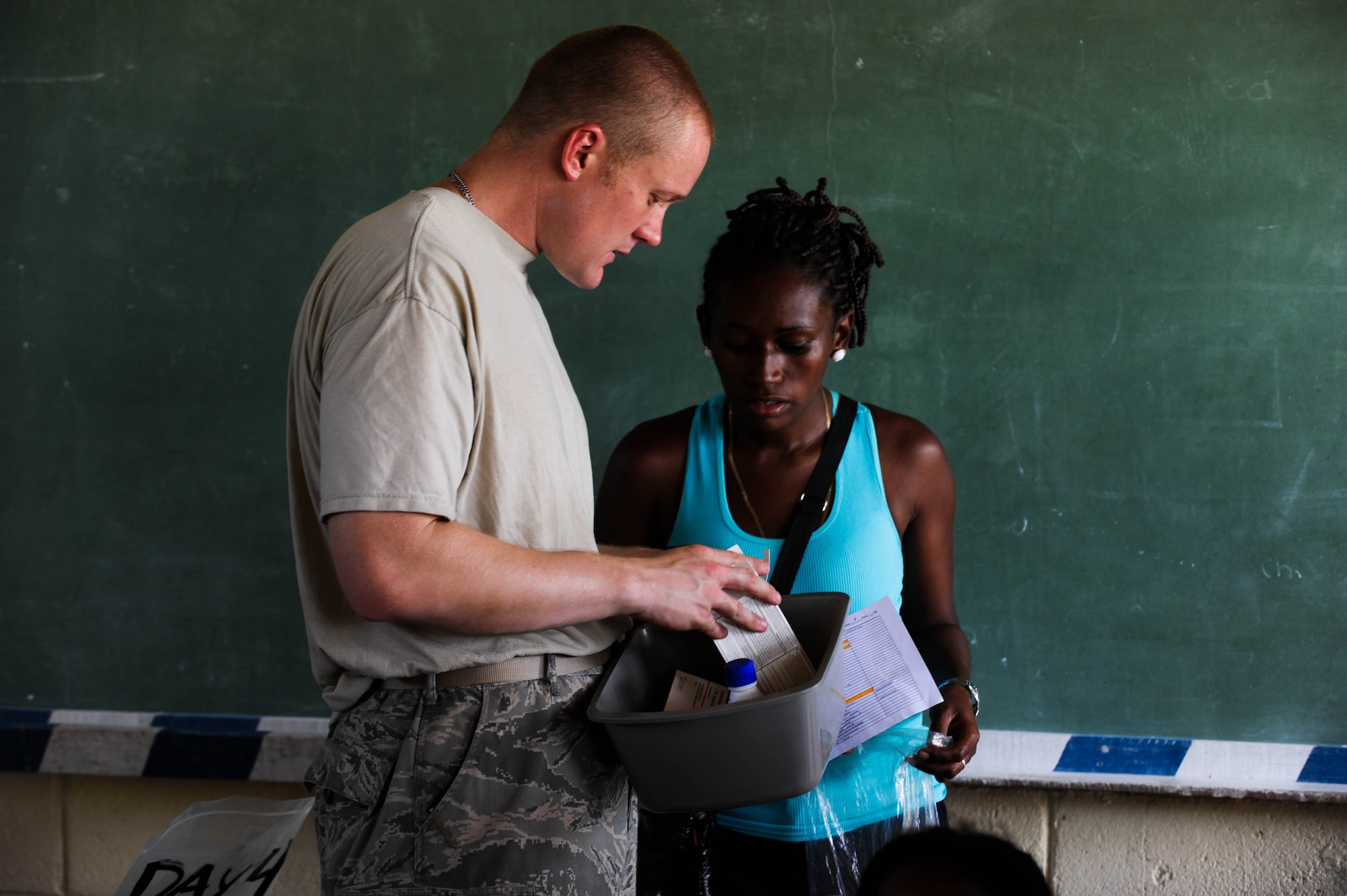 BATALLA, Honduras -- Air Force Staff Sergeant Thomas Delperdang, Medical Element Pharmacy Technician explains to a patient the prescription medication she is receiving with proper instructions on use during JTF-Bravo's most recent medical readiness and training exercise. In partnership with the Honduran Ministry of Health and Honduran Military, JTF-Bravo delivered medical care to 1,774 patients in Batalla and Wawina during the MEDRETE, April 18-21. (U.S. Air Force Photo/1st Lt. Christopher Diaz)