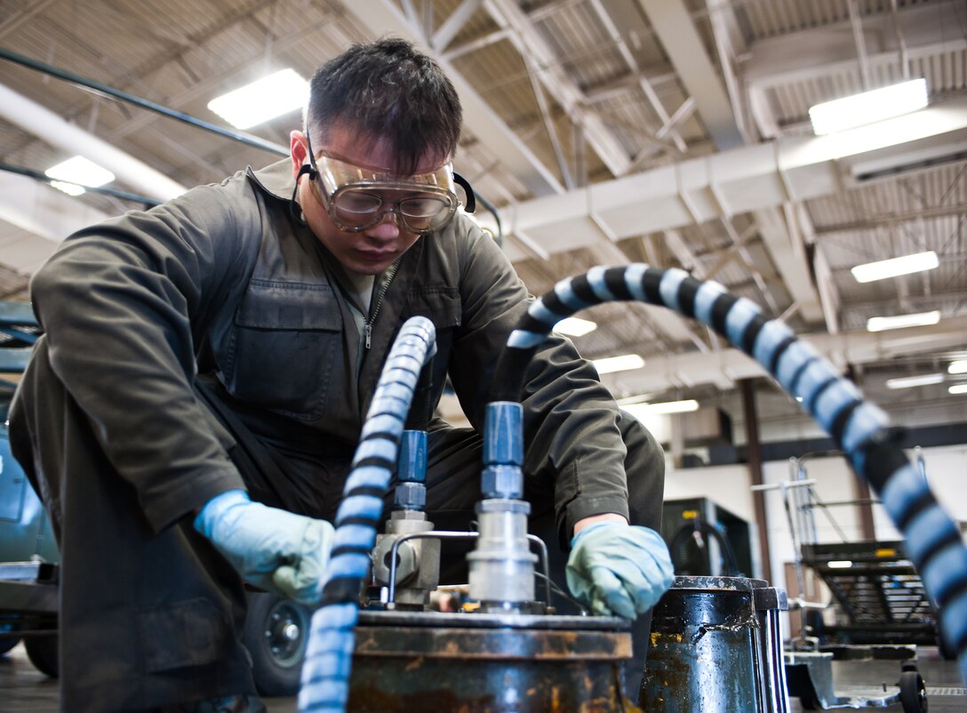 Airman 1st Class Chun Liu, 28th Maintenance Squadron aerospace ground equipment technician, seals an oil cart lid during scheduled maintenance at Ellsworth Air Force Base, S.D., April 18, 2012. AGE technicians service, inspect, troubleshoot, repair and perform preventive maintenance on engine-driven generator sets, air conditioners, hydraulic test stands, air compressors, bomb lifts, heaters and other support equipment. (U.S. Air Force photo by Airman 1st Class Alystria Maurer/Released)