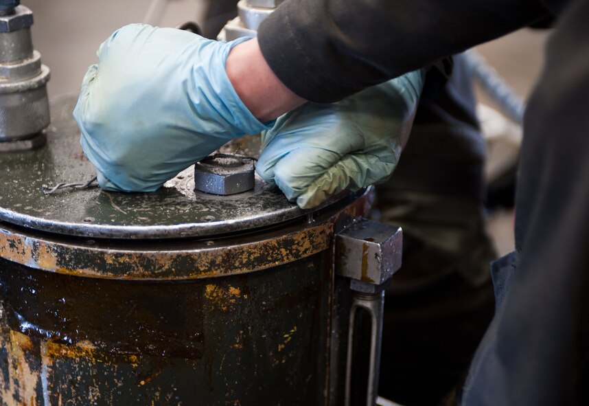 Airman 1st Class Chun Liu, 28th Maintenance Squadron aerospace ground equipment technician, secures a lid to an oil cart during scheduled maintenance at Ellsworth Air Force Base, S.D., April 18, 2012. A proper seal is necessary to ensure the oil cart is secure while operating inside the B-1 bomber. (U.S. Air Force photo by Airman 1st Class Alystria Maurer/Released)