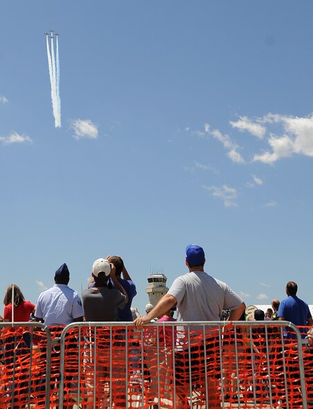 Spectators watch as the Black Diamond Jet Team performs an aerial act during the 2012 Barksdale Air Force Base Defenders of Liberty Air Show April 22. The annual air show featured several aerial demonstration acts, headlined by the U.S. Air Force Air Demonstration Squadron Thunderbirds. (U.S. Air Force photo/Staff Sgt. Amber Ashcraft) (RELEASED)