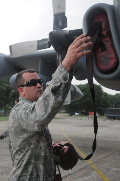 KURMITOLA AIR BASE, Bangladesh — Staff Sgt. Chris Larimore, a communications navigation specialist from the Kentucky Air National Guard, plugs a  C-130H aircraft to protect against debris damage as part of post-flight procedures during Cope South 2012 at Kurmitola Air Base, Bangladesh, April 21, 2012. During Cope South 2012, U.S. and Bangladesh Air Forces will exchange airlift, air-land, and airdrop delivery techniques that will enhance the ability to respond to regional disasters. (U.S. Air Force photo by 1st Lt Cammie Quinn)
