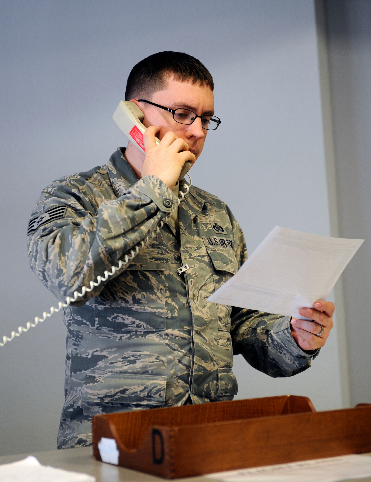 Staff Sgt. Joseph Sigmon, 2nd Operations Support Squadron, looks over a military flight plan as he talks to an Airman in the control tower during the 2012 Barksdale Air Force Base Defenders of Liberty Air Show April 22. Sigmon provided the control tower information on the departure of outbound aircraft. The military flight plan, or DD Form 175, is used by the base to keep track of aircraft routes, destinations and air speed. (U.S. Air Force photo/Airman 1st Class Benjamin Gonsier)(RELEASED)
