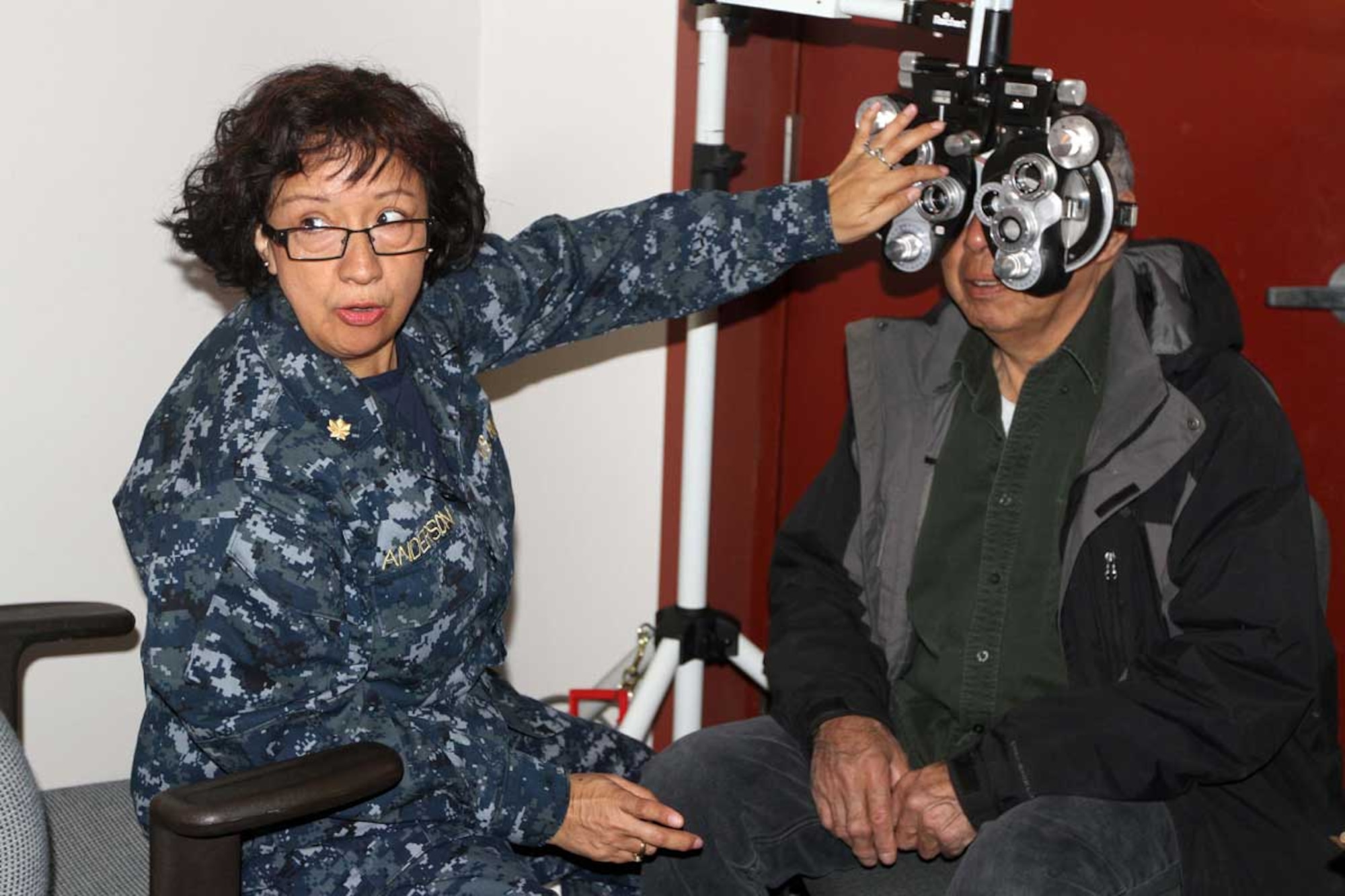 Lt. Commander Patricia Anderson, Navy Reserve optometrist, assists a patient during an eye exam at the Alaska National Guard armory in Nome Monday. Optometrists have performed 1,697 procedures, assisting 582 patients during Arctic Care 2012. (Alaska National Guard photo/Air Force Maj. Guy Hayes)