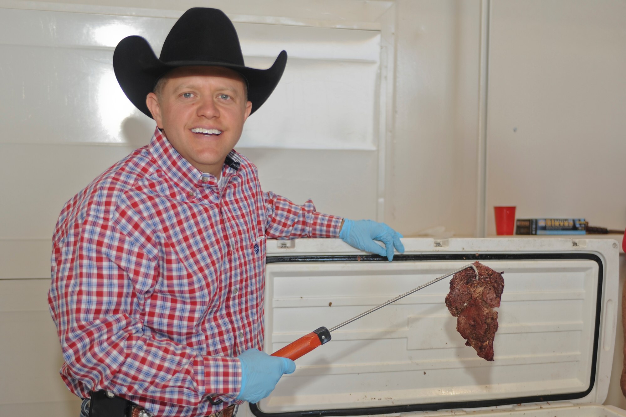 Matt Rush serves steaks to Cannon Air Commandos and their families as a Steaks For Airmen volunteer at Cannon Air Force Base, N.M., April 21, 2012.  The All-American Beef Battalion sponsored the Steaks For Airmen event, serving Airmen and their families 1000 18-20oz steaks and 300 quarter-pound hotdogs. (U.S. Air Force photo by Airman 1st Class Ebon Reece)