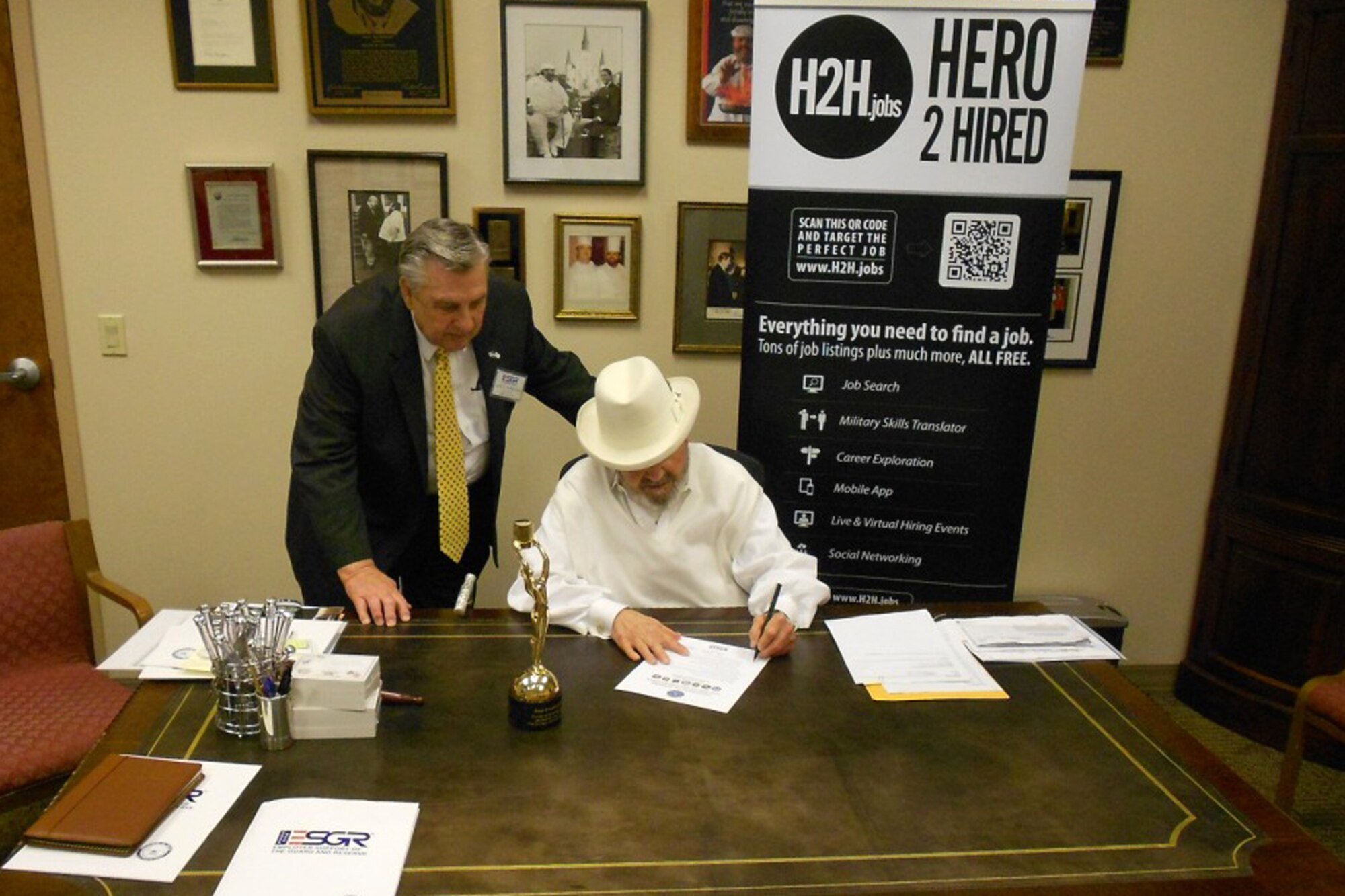 Jack Humphries, Louisiana Committee State Chair of the Employer Support of the Guard & Reserve, watches as Louisiana’s Famous Chef Paul Prudhomme, the owner of K-Paul’s Kitchen and Magic Seasoning Blends, signs a statement of support for the Guard and Reserve in his office April 10, 2012. The statement of support has been the cornerstone of the ESGR effort to gain and maintain employer support. The intent of the program is to increase employer support of the Guard and Reserve by developing employers that advocate for employee participation in the military. (Courtesy photo) 