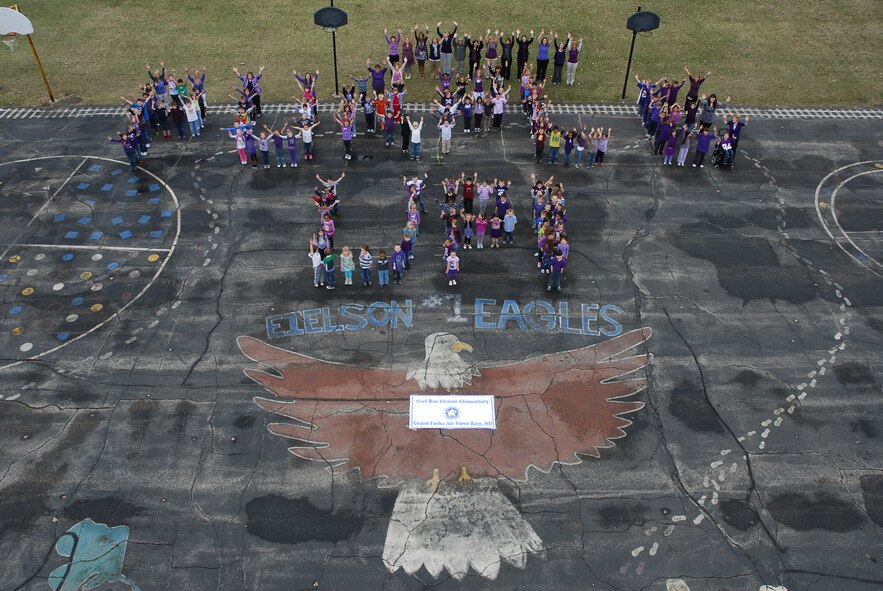 Eielson Elementary School students - kindergarten through third grade - pose for a "Purple Up Day" photo shoot on Grand Forks Air Force Base, N.D., on April 13, 2012. Children were urged to wear purple in an effort to honor military kids from each branch of the military and the sacrifices they make being a military kid.  (U.S. Air Force photo/Brad Painter)