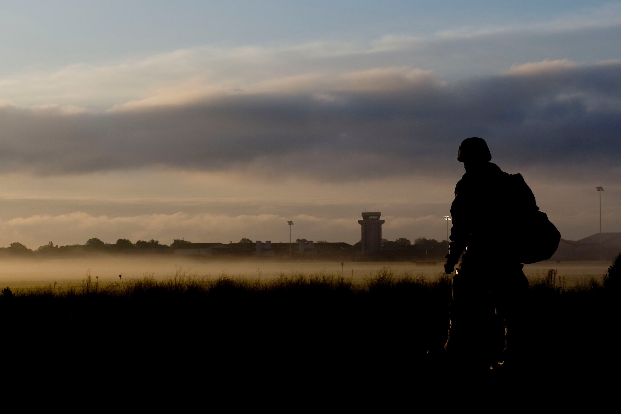 A raptor town Airmen walks to the bus stop after a shift change during exercise Coronet White at the Raptor Town entry control point at Langley Air Force Base, Va., April 20. The Phase I and Phase II exercise was held to validate the full spectrum of Langley's deployment operations. (U.S. Air Force photo by Senior Airman John D. Strong II/Released)