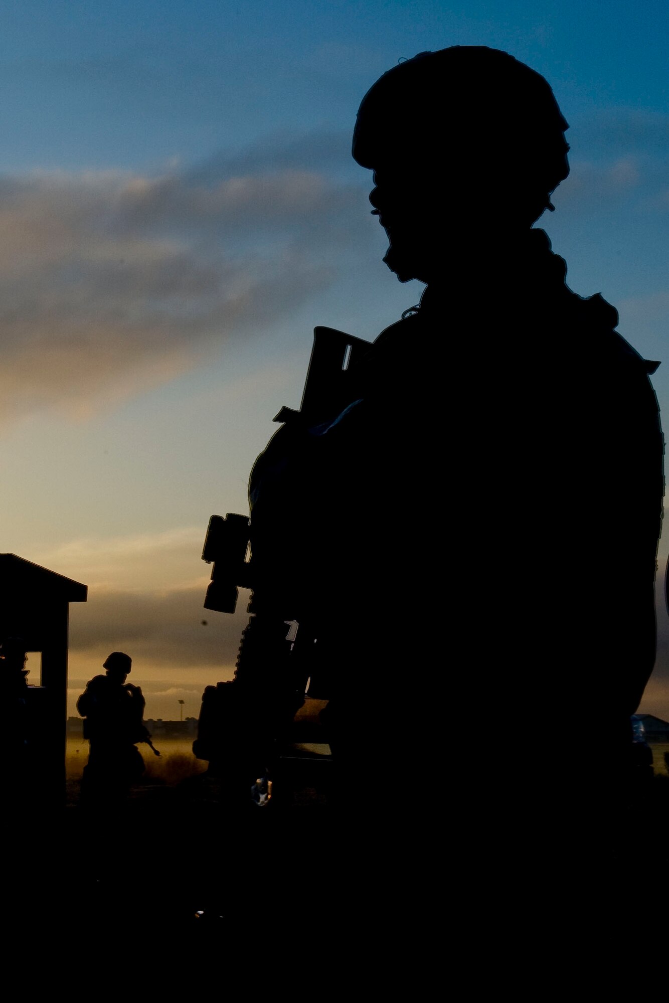 Airman 1st Class Kyle Dehaan, 633rd Security Forces Squadron entry control point guard, stands vigilant during exercise Coronet White at the entry control point in Raptor Town at Langley Air Force Base, Va., April 20. The Phase I and Phase II exercise was held to validate the full spectrum of Langley's deployment operations. (U.S. Air Force photo by Senior Airman John D. Strong II/Released)