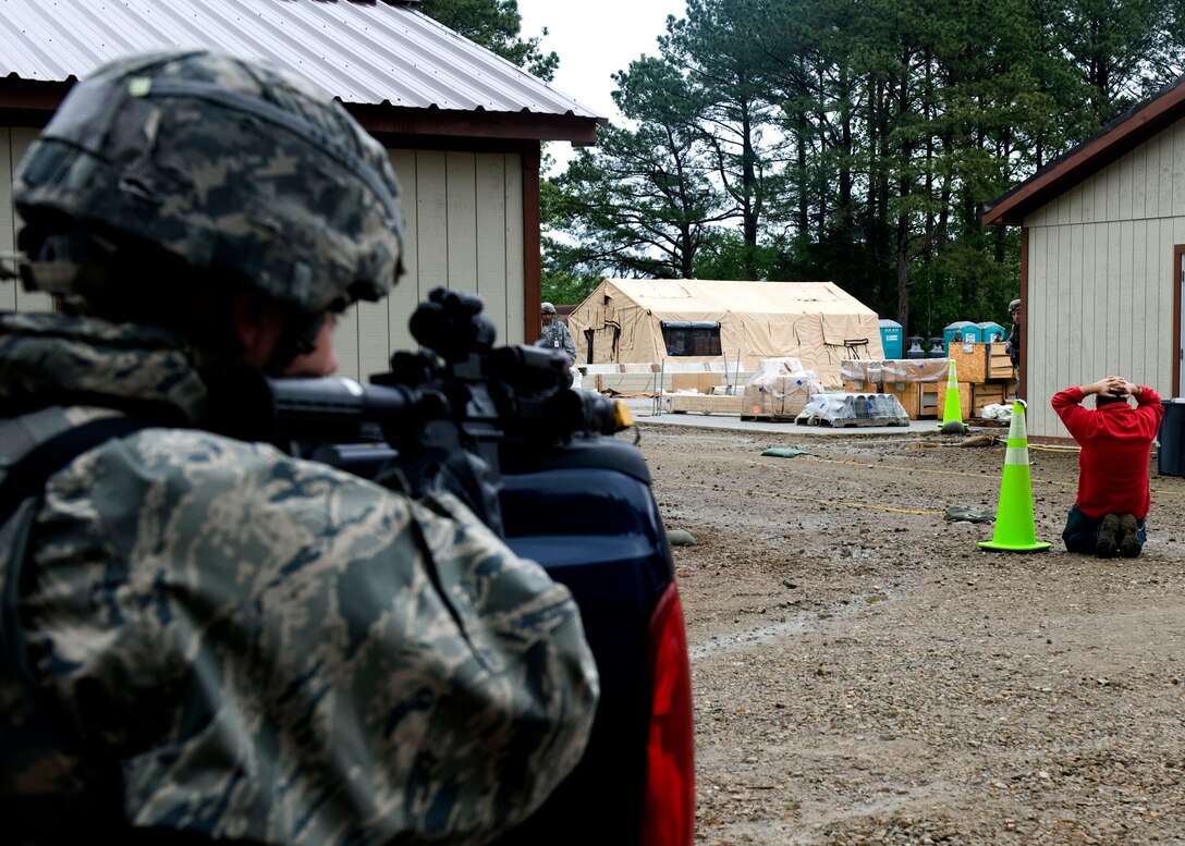 A member of the 633rd Security Forces Squadron apprehends an intruder during exercise Coronet White in Raptor Town at Langley Air Force Base, Va., April 19. The Operational Readiness Exercise was held to help Langley Airmen to prepare for the upcoming Operational Readiness Inspection. (U.S. Air Force photo by Senior Airman John D. Strong II/Released)