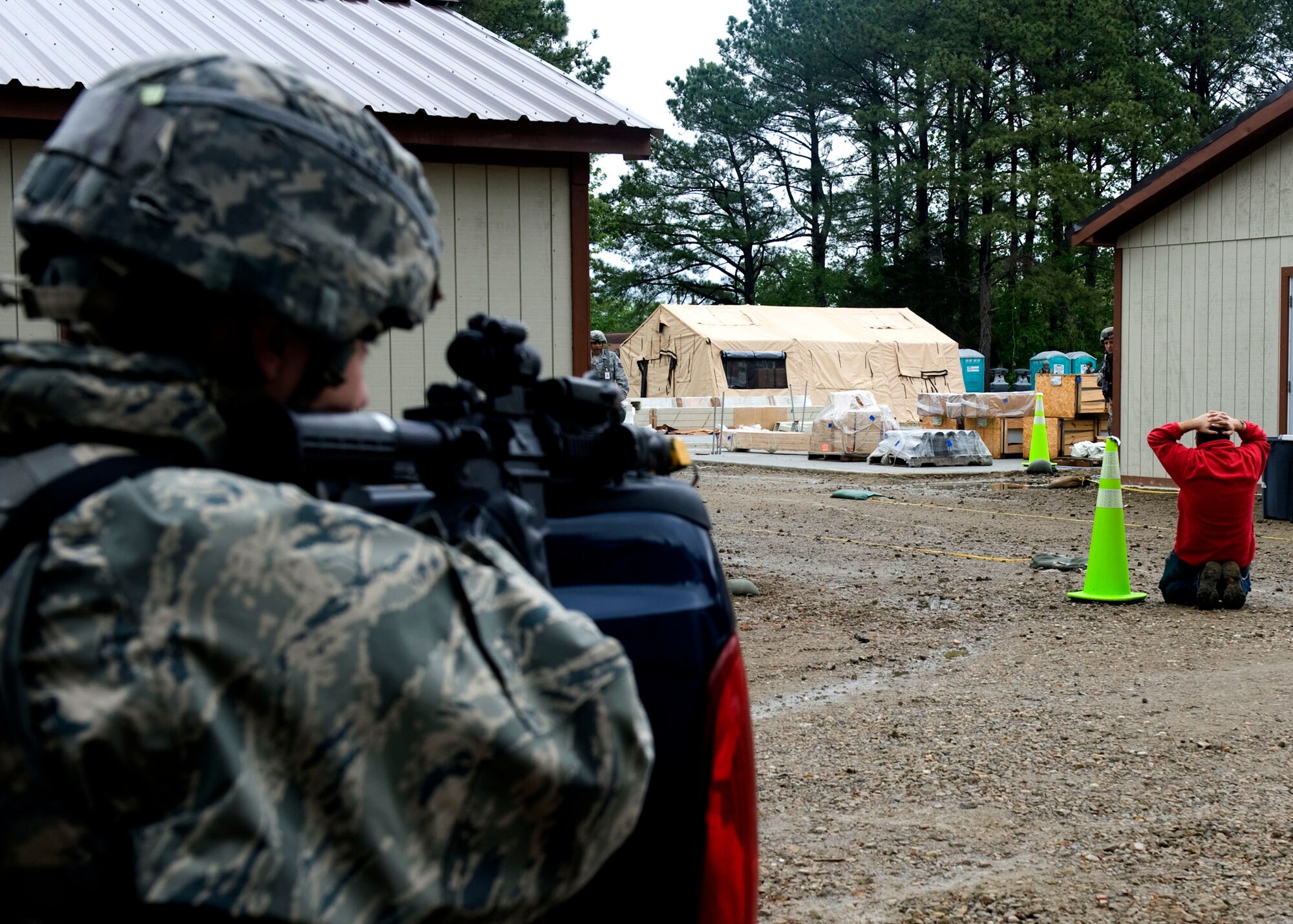 A member of the 633rd Security Forces Squadron apprehends an intruder during exercise Coronet White in Raptor Town at Langley Air Force Base, Va., April 19. The Operational Readiness Exercise was held to help Langley Airmen to prepare for the upcoming Operational Readiness Inspection. (U.S. Air Force photo by Senior Airman John D. Strong II/Released)