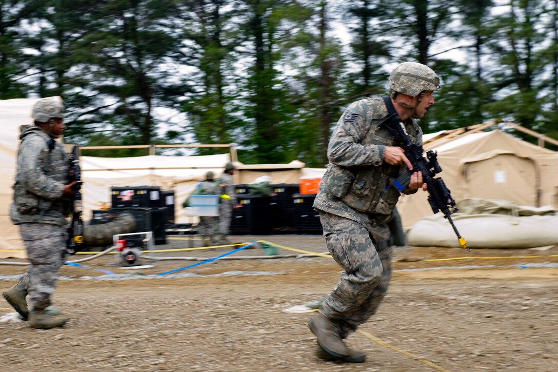 Tech. Sgt. Brandon Binczac, 633rd Security Forces Squadron Combat Arms instructor, sprints in response to an intruder alert during exercise Coronet White in Raptor Town at Langley Air Force Base, Va., April 19. The Phase I and Phase II exercise was held to validate the full spectrum of Langley's deployment operations. (U.S. Air Force photo by Senior Airman John D. Strong II/Released)