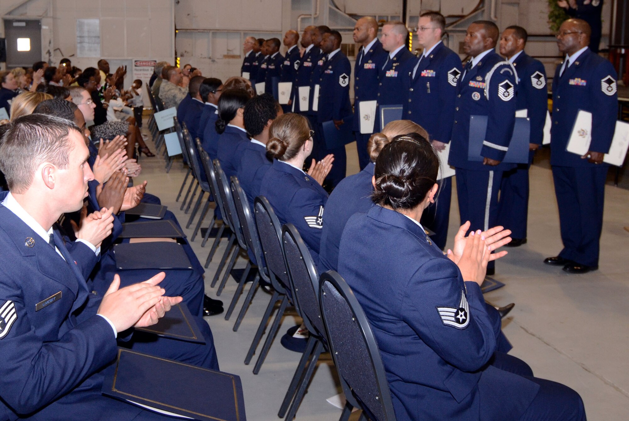 Family, friends and fellow reservists applaud the newly appointed Senior Noncommissioned Officers during an NCO and SNCO Induction Ceremony April 14. (U.S. Air Force photo/Don Peek)