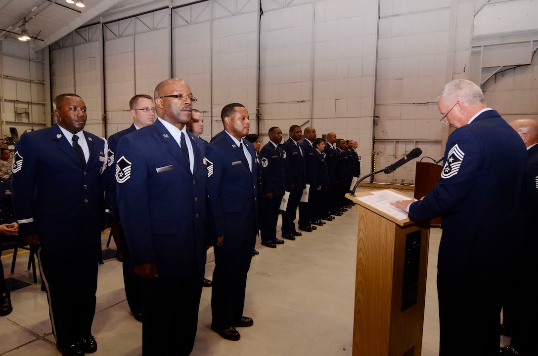Chief Master Sgt. Wendell L. Peacock, 94th Airlift Wing command chief administers the SNCO Charge to those Senior Noncommissioned Officers newly inducted at a ceremony April 14. (U.S. Air Force photo/Don Peek)