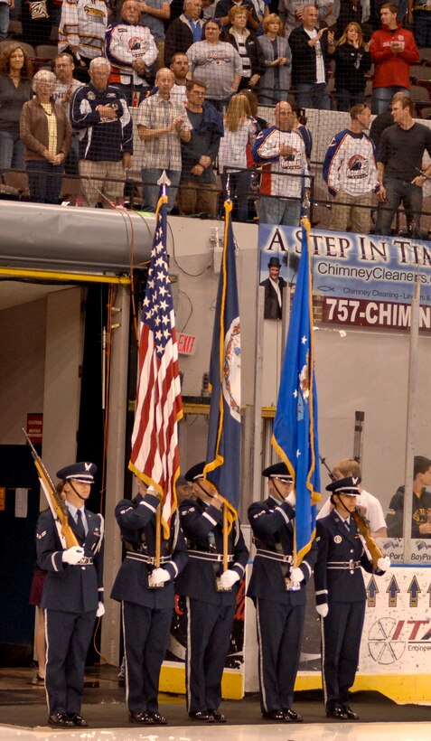 Members of the Langley Air Force Base Honor Guard present the colors prior to the start of the Norfolk Admirals hockey game at Scope arena, Apr. 21, 2012. Presenting the colors during the national anthem is a longstanding tradition before professional sporting events. (U.S. Air Force photo by Senior Airman Wesley Farnsworth)