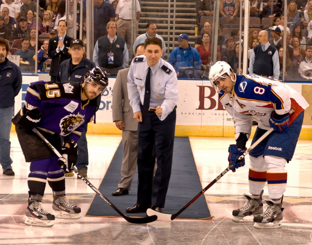 Col. Korvin Auch, 633rd Air Base Wing commander, drops the ceremonial puck prior to the start of the Norfolk Admirals hockey game at Scope arena, Apr. 21, 2012. The Admirals fell to the Manchester Monarchs with a score of 5-2, breaking a 20 plus game winning streak. (U.S. Air Force photo by Senior Airman Wesley Farnsworth)