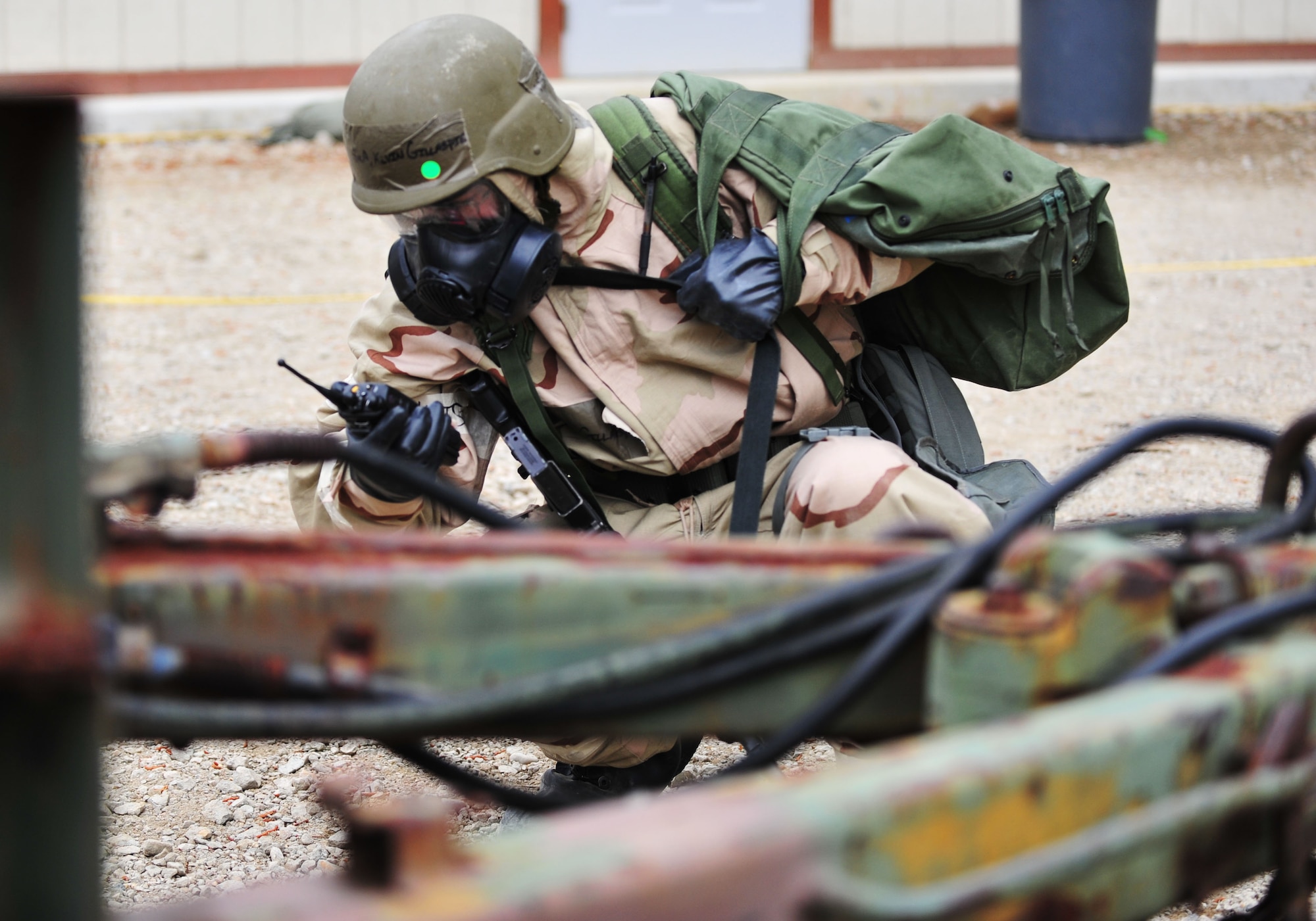 U.S. Air Force Airman 1st Class Kevin Gillaspie, 633rd Civil Engineer Squadron post attack reconnaissance team member, reports the simulated contamination of a water drum during a Phase II Operational Readiness Exercise at Langley Air Force Base, Va., April 20, 2012. After a chemical attack, Airmen are required to sweep the area and search for any possible contamination. (U.S. Air Force photo by Senior Airman Jarad A. Denton/Released)