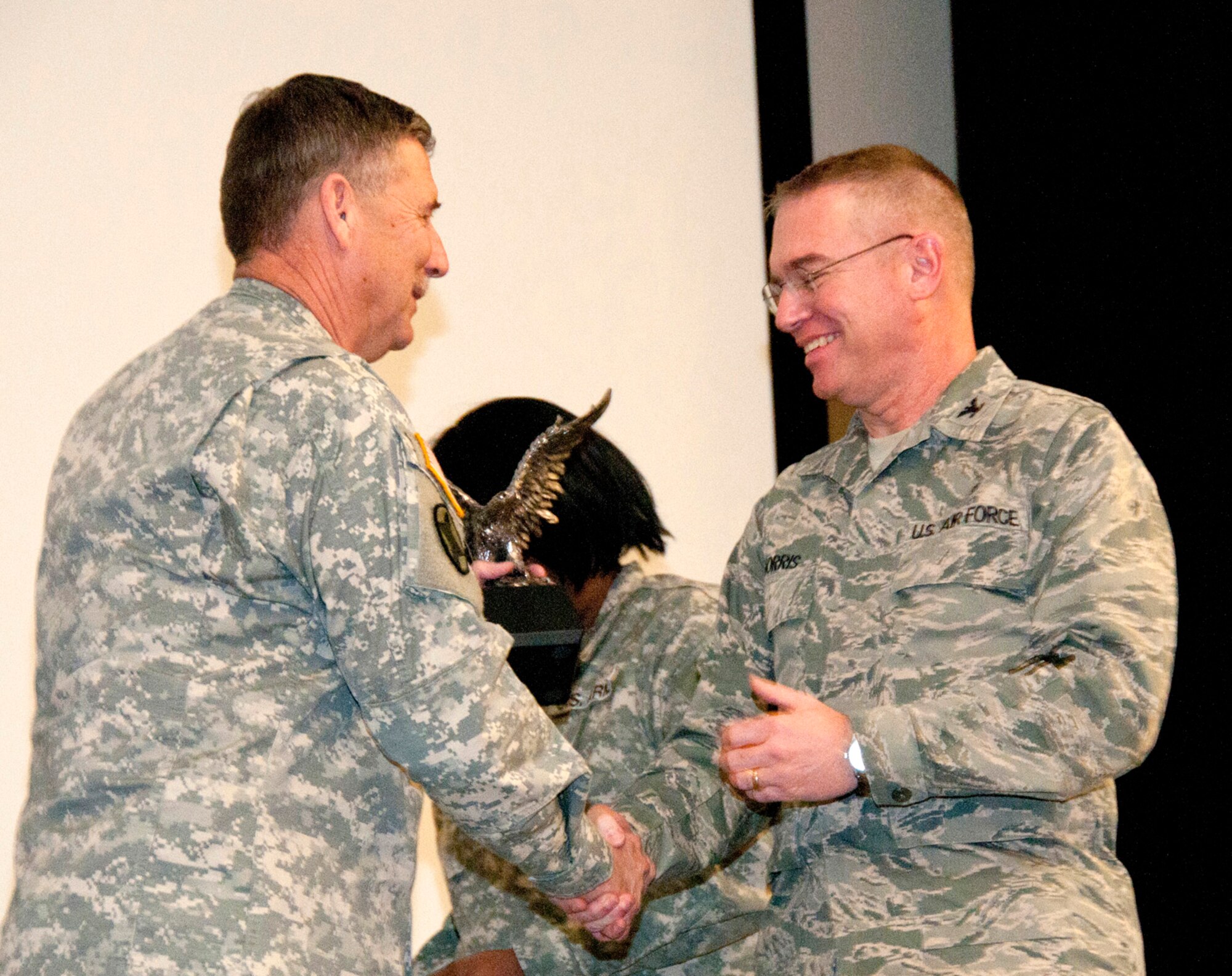 Col. Paul Norris, 188th Medical Group commander, right, receives recognition from Maj. Gen. William D. Wofford, the adjutant General of the Arkansas National Guard, during a Hometown Heroes Salute ceremony at Camp Joseph T. Robinson, Ark., March 4, 2012. Members of the Arkansas National Guard’s second Agriculture Development Team conducted many training seminars for small farmers in various districts around Zabul Province in Southern Afghanistan, covering multiple topics including, orchard and pasture management, wheat and garden crops, irrigation and water management, soil improvement, and pest and disease management. (U.S. Air Force photo by Tech Sgt. Billie J. Thompson)
