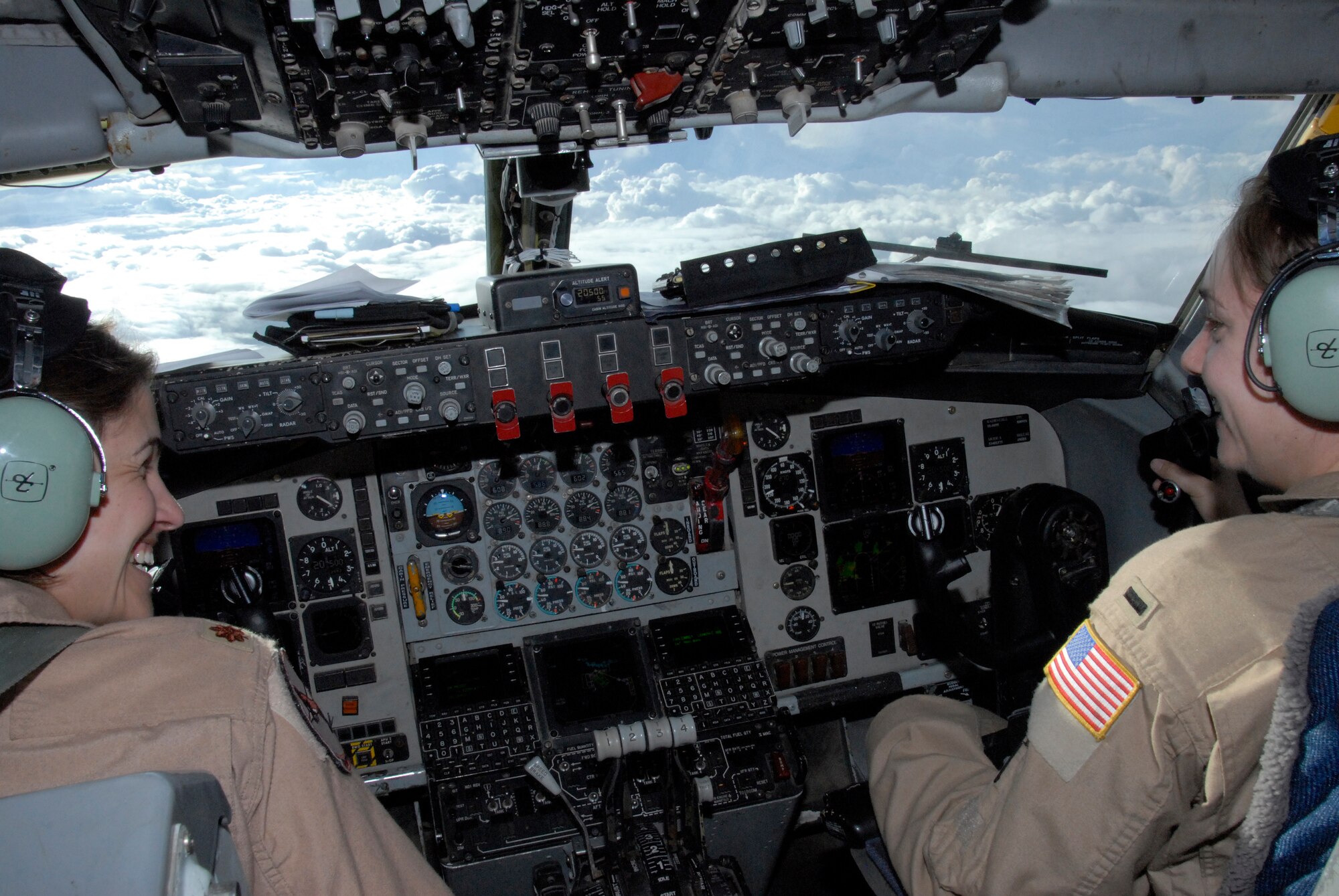 (l) Maj. Kristen Westby, 22nd Expeditionary Air Refueling Squadron pilot and (r) 1st Lt. Melissa Evans, 22 EARS co-pilot, share a laugh while commanding an in-flight refueling mission on a KC-135 Stratotanker April 19, 2012. Wesby is deployed to the Transit Center at Manas, Kyrgyzstan, from the 93rd Air Refueling Squadron at Fairchild Air Force Base, Wash. Evans is deployed here from March Air Reserve Base, Calif. (U.S. Air Force photo/Senior Airman Lynsie Nichols)